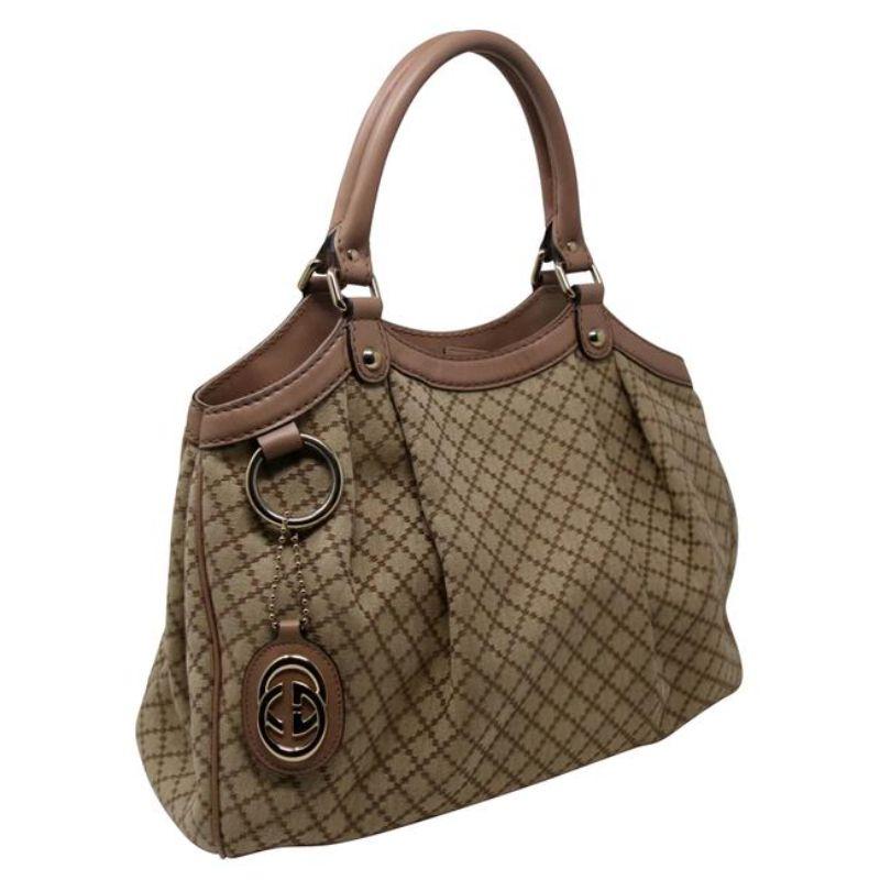 Sukey Hobo Brown Monogram Canvas Shoulder Bag

Beautiful Peach Gucci Tote Medium is a chic tote ideal for your everyday wear. Crafted from brown canvas Gucci canvas & elegant GG Drop charm and pretty touch of peach leather detail, features