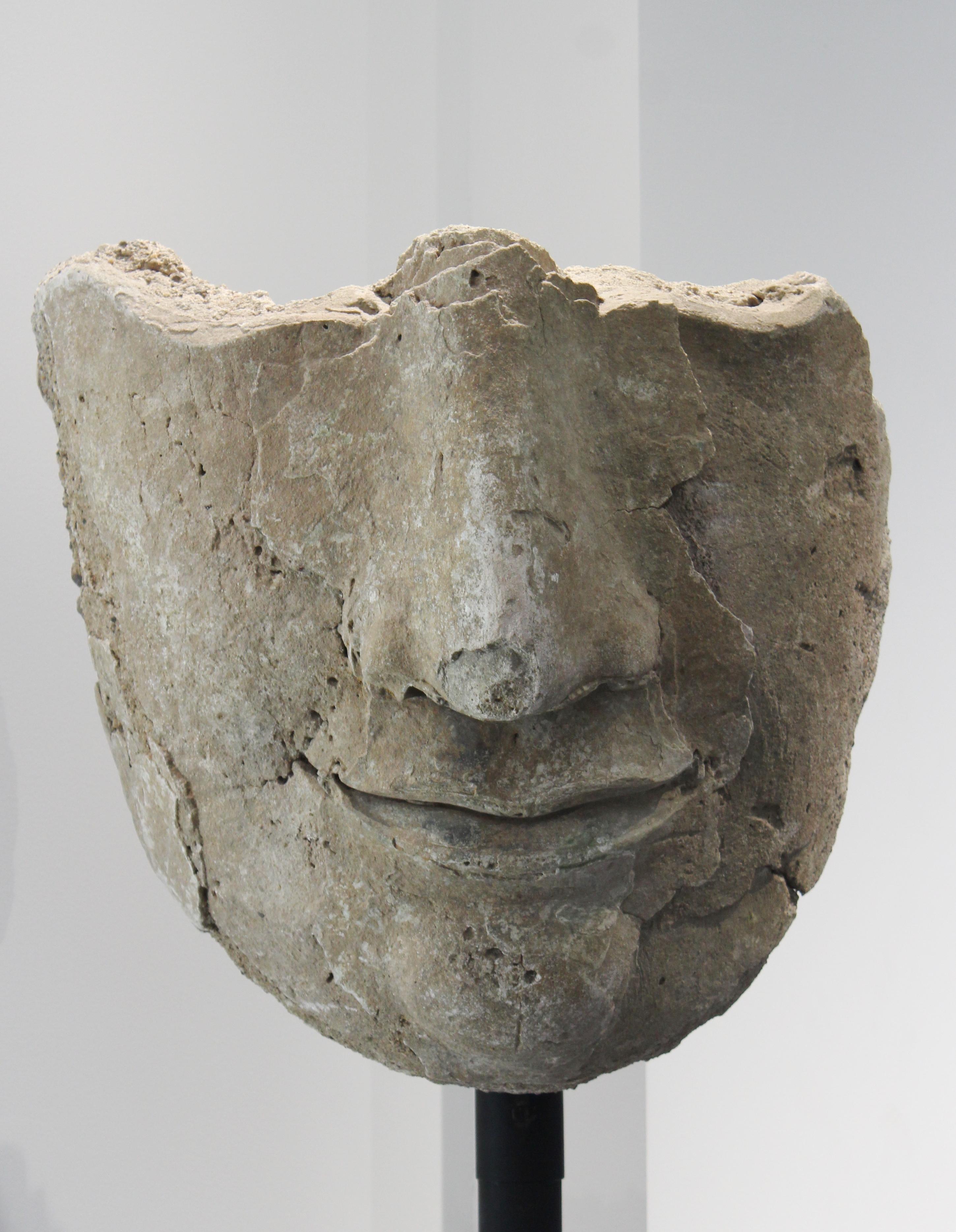 Sukhothai period fragmentary stucco head of Buddha or Bodhisattva with custom made stand, mounted on pedestal, circa 1450. Reported recovered from the central sanctuary tower of the Wat Phrai Phai Luang (the 'Temple of The Great Wind' founded under