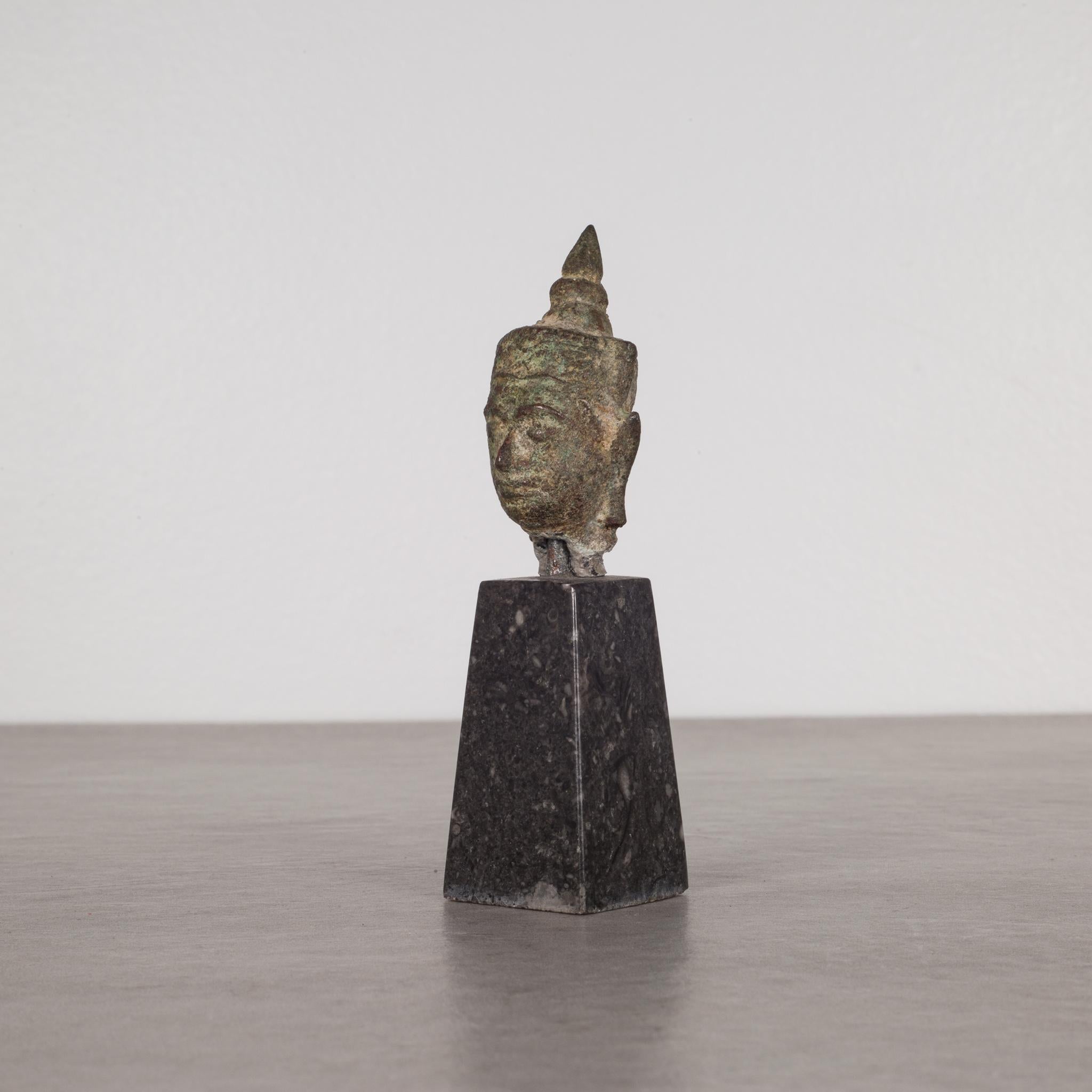 About

This is an original lost-wax casting bronze head of Buddah Shakyamuni from the 19th century, Thailand. It is mounted on a contemporary marble base. His meditative expression, arched eyebrows, downcast eyes, smiling lips, elongated earlobes