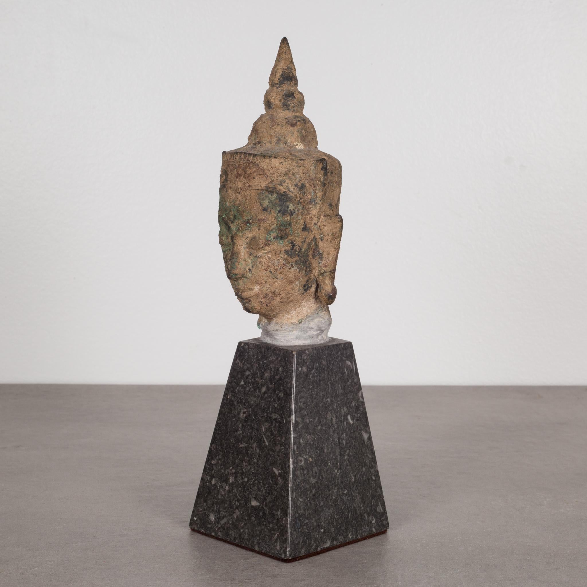 About

This is an original lost-wax casting bronze head of Buddah Shakyamuni from the 19th century, Thailand. It is mounted on a contemporary marble base. His meditative expression, arched eyebrows, downcast eyes, smiling lips, elongated earlobes