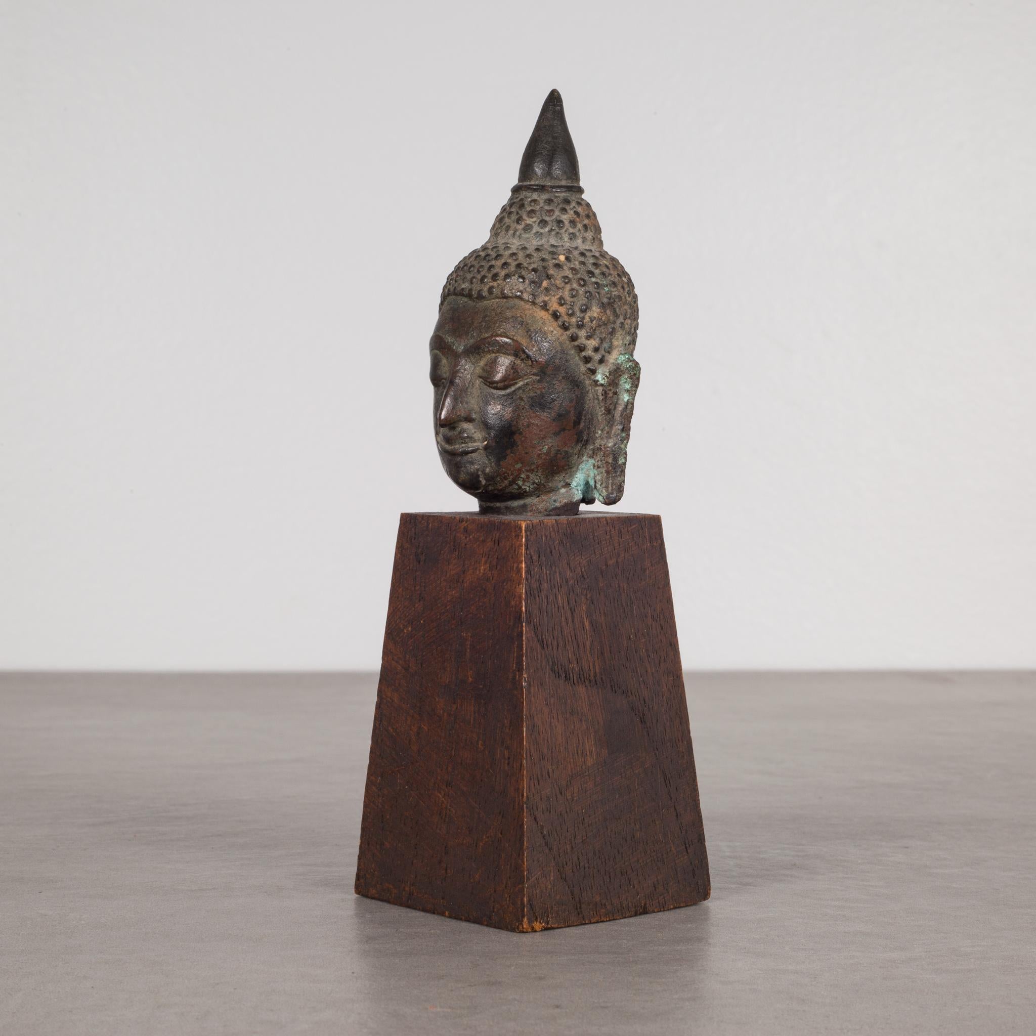 About

This is an original lost-wax casting bronze head of Buddah Shakyamuni from the 19th century, Thailand. It is mounted on a contemporary wood base. His meditative expression, arched eyebrows, downcast eyes, smiling lips, elongated earlobes and