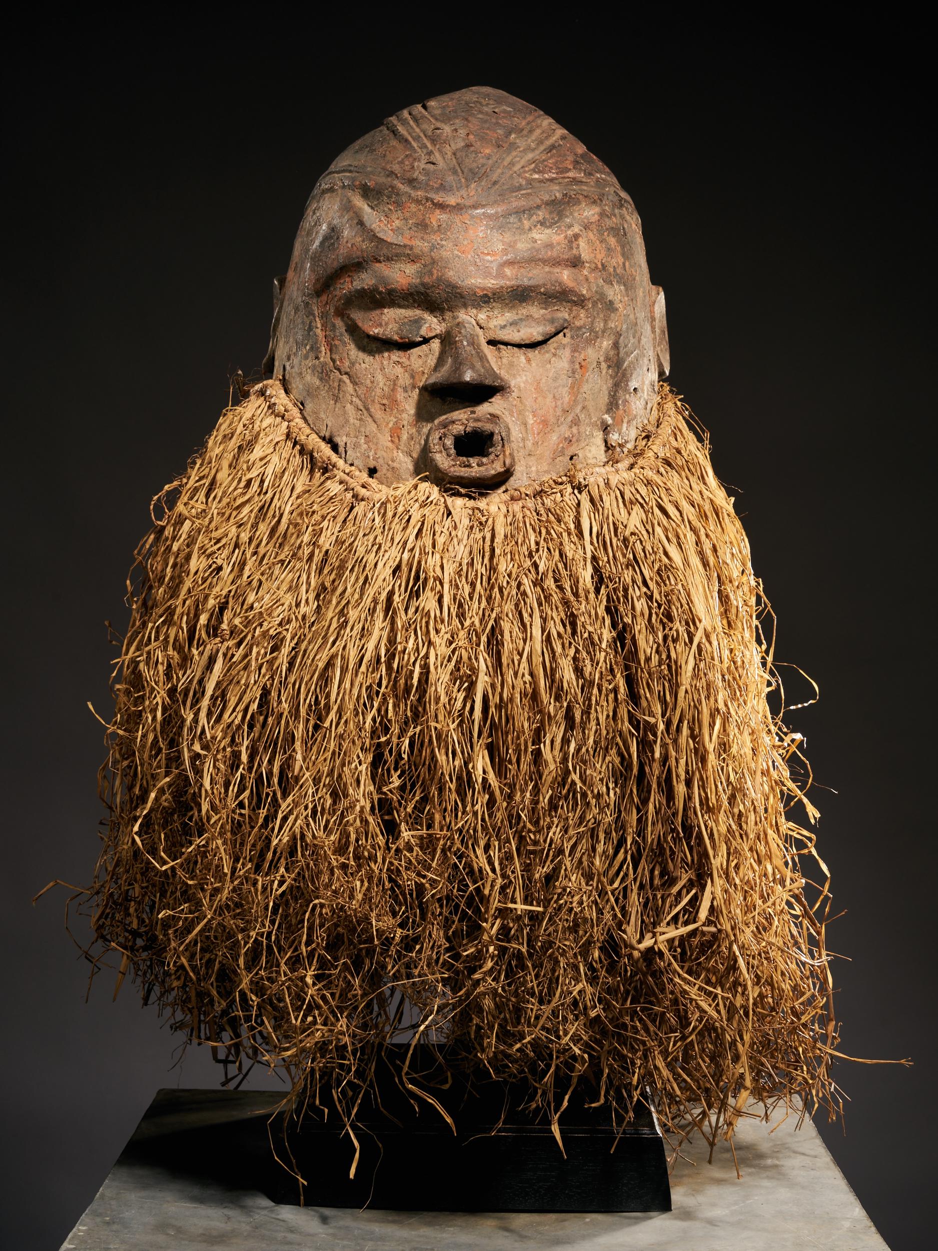 This Suku helmet mask has quite a striking appearance. The closed eyes give the mask an introverted aura, while the lips are pursed, as if making a sound or singing. The top of the head is decorated with carvings and of course the most striking