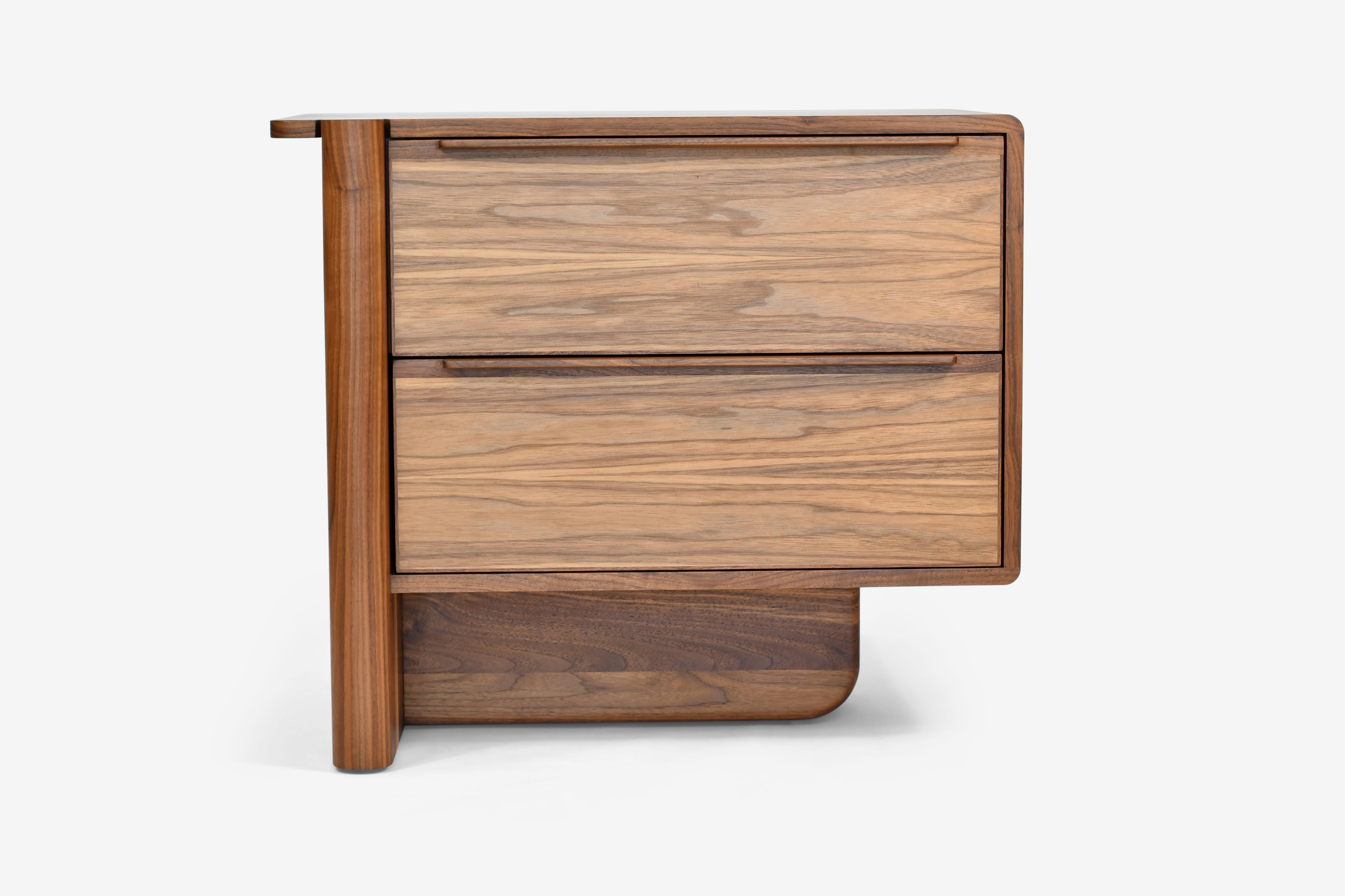 The Sulaco two drawer side table features an elevated blend of clean lines with its asymmetrical organic form all while providing a tailored look that still manages a broad range of versatility. The addition of the second drawer provides for ample