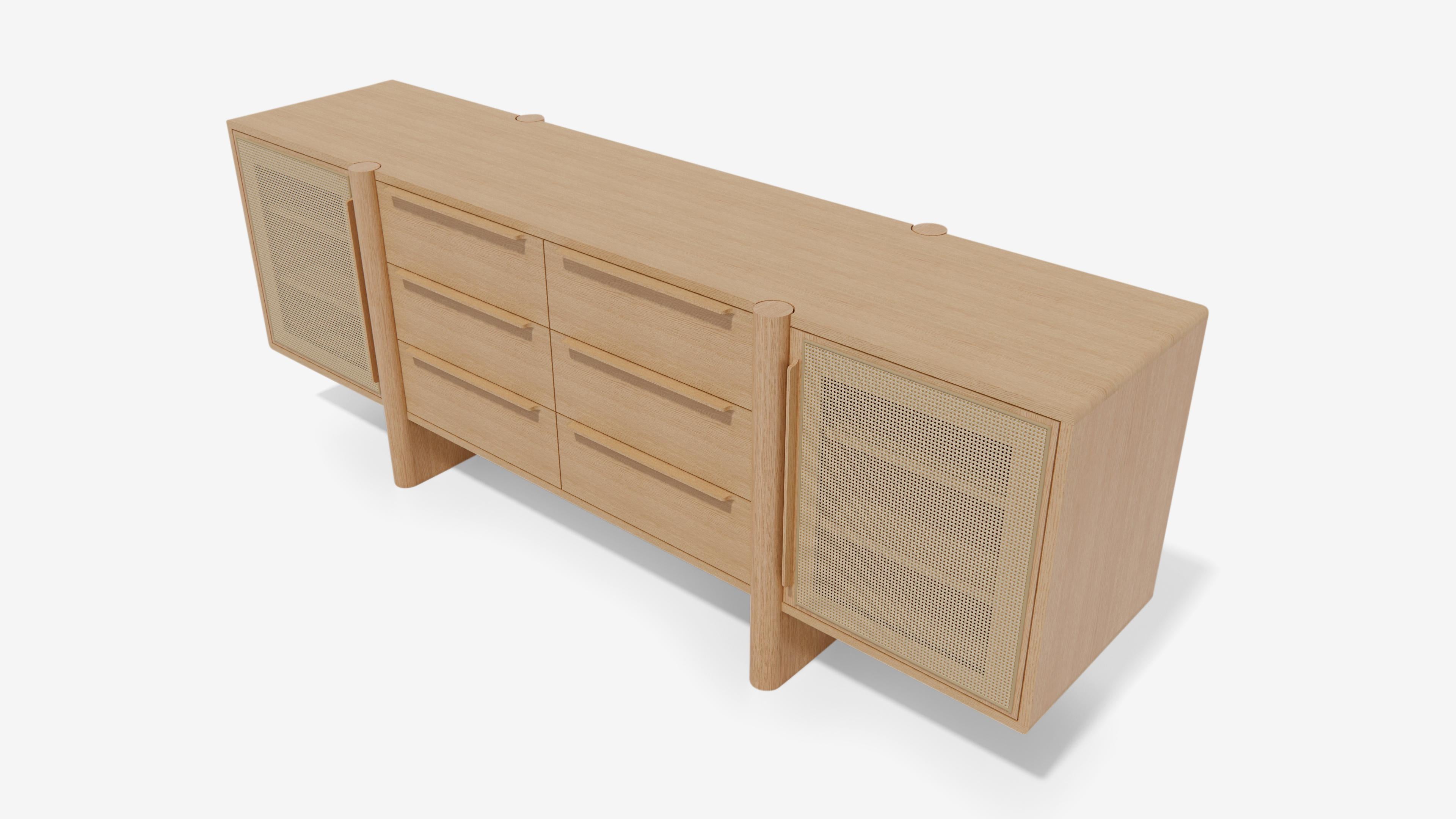 The Sulaco Sideboard features an elevated blend of clean lines with its organic form all while providing a tailored look that still manages a broad range of user versatility. 

The textured addition of the caned panel doors provides a Classic