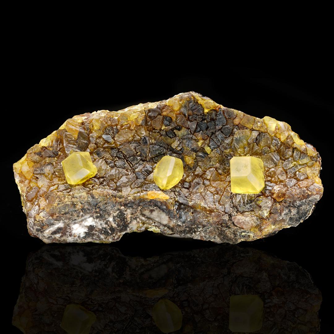This rare collector's specimen came out of a famous pocket in Sicily in the 1970s and exhibits the large crystals, excellent clarity, and isolation of crystals for which the location is known. These gemmy, fully formed single sulfur crystals grow on