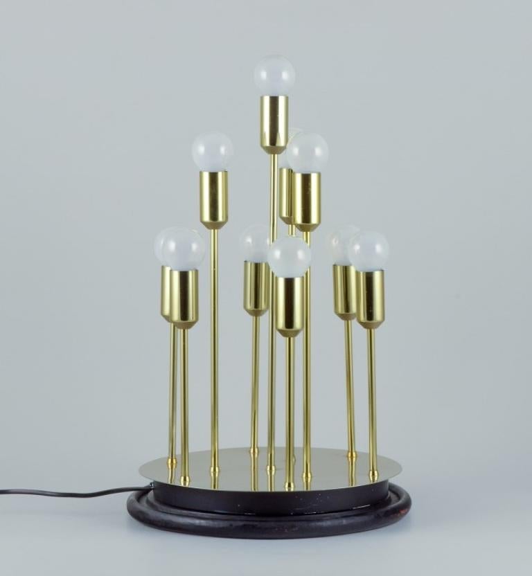 Sülken Leuchten, Germany, modernist lamp for ten bulbs.
Brass on a black wooden base.
1970s/80s.
Perfect condition.
Dimensions: H 51.0 cm x D 30.0 cm.