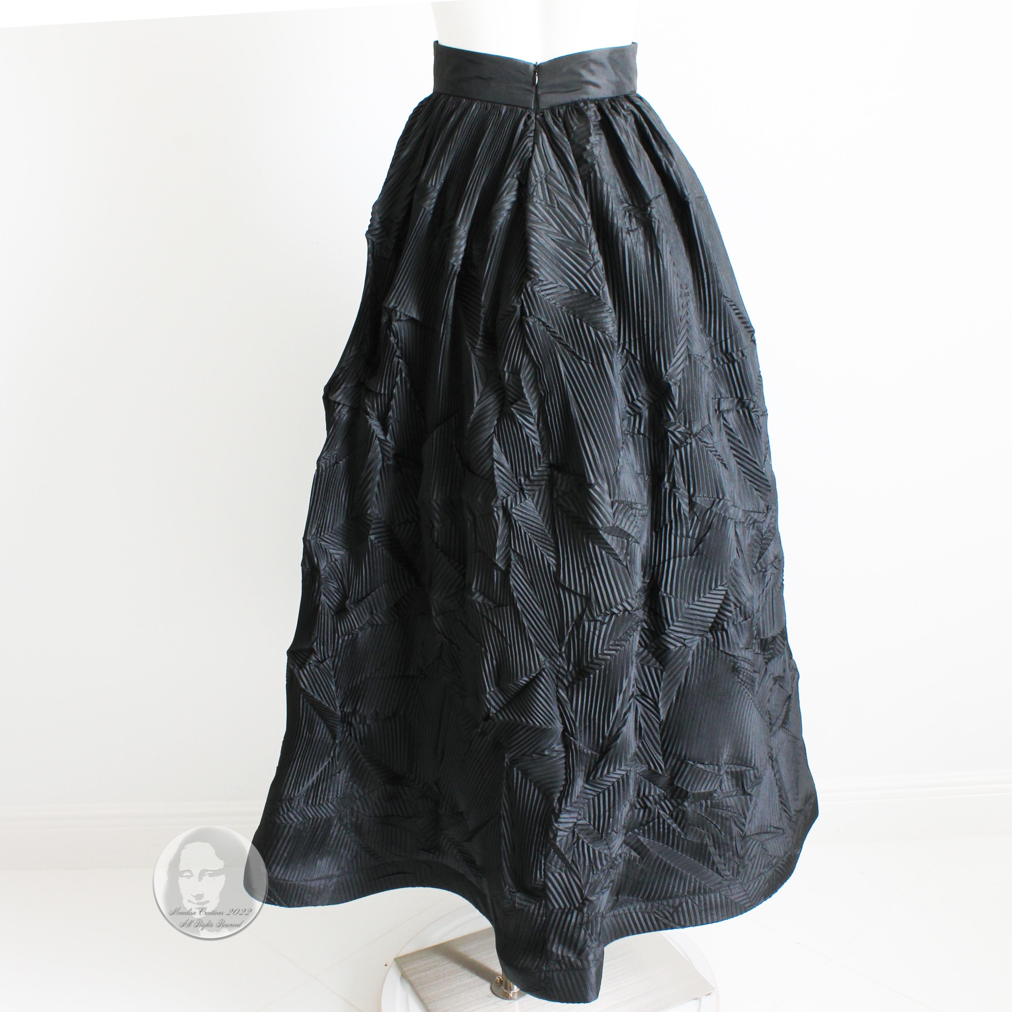This stunning formal skirt was made by designer Sully Bonnelly (designer for Mizrahi), most likely in the 90s.  Made from what we believe is a rayon blend fabric (no content tags), this piece features TONS of pleats in various patterns throughout!