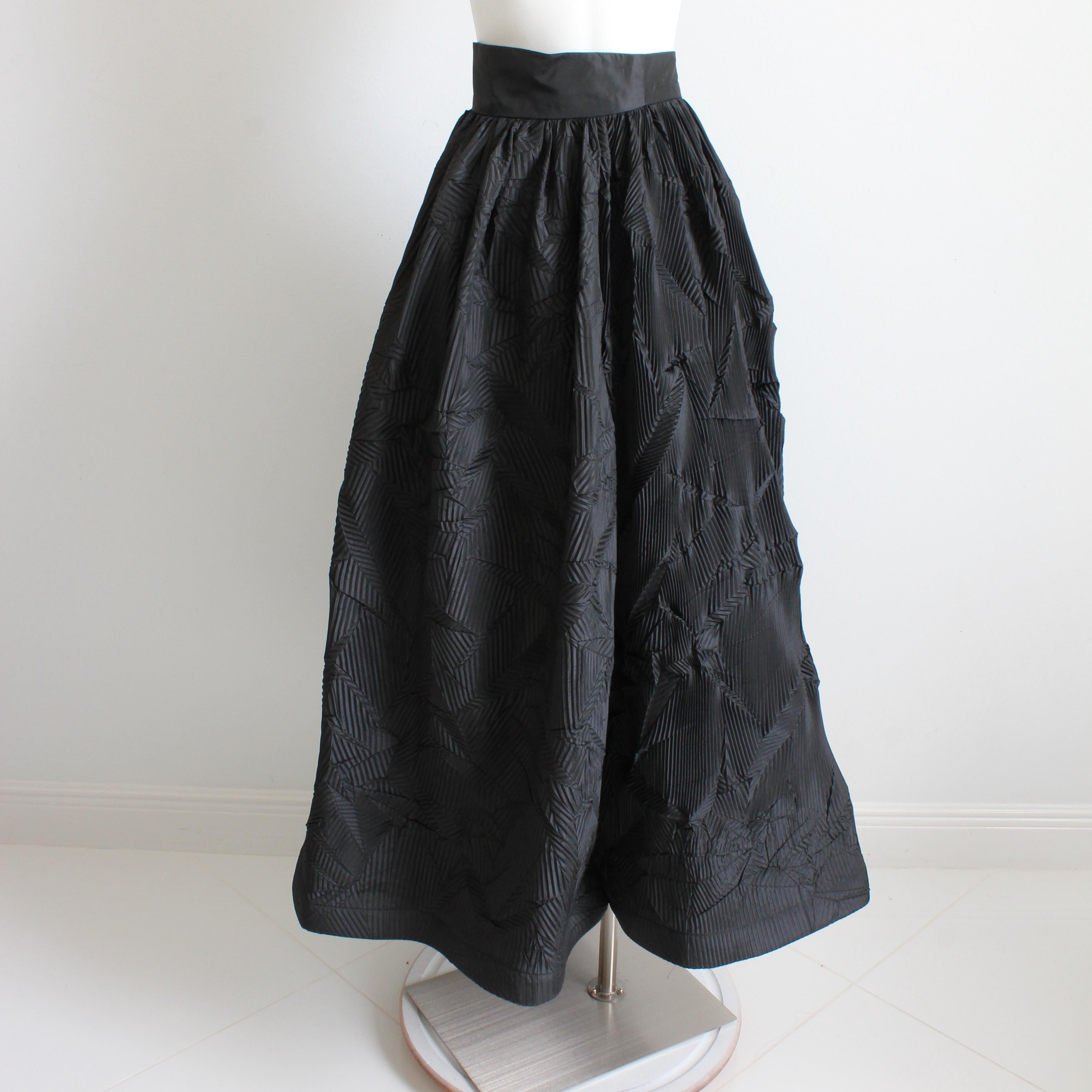 This stunning formal skirt was made by designer Sully Bonnelly, most likely in the 90s.  Made from what we believe is a rayon blend fabric (no content tags), this piece features TONS of pleats in various patterns throughout! Both the lining and the