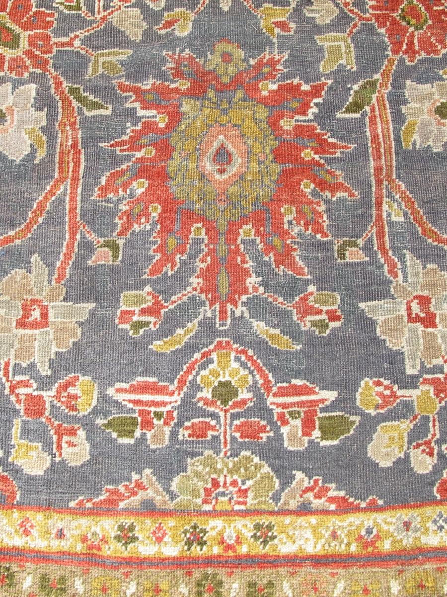 Great Sultanabad carpets blend bold design elements with compelling scale and a rich sophisticated palette. This piece does not disappoint. Three columns of large-scale ornament derived from an eighteenth-century Persian floral ‘harshang’ design are