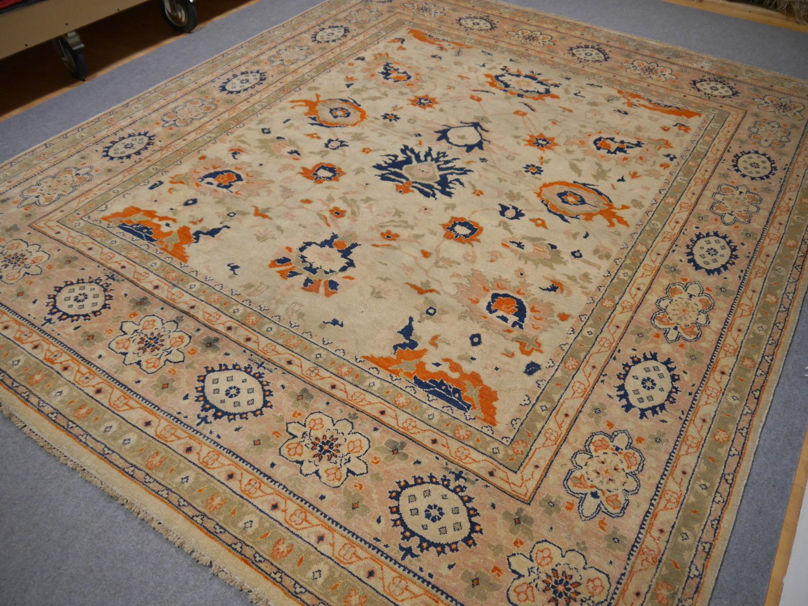 A beautiful circ 8 x 10 ft contemporary design carpet, hand knotted using finest wool. On a light crème field, the design of Lotus blossoms standing next to each other executed in orange, blue and green tones.
Design influences are from Persian