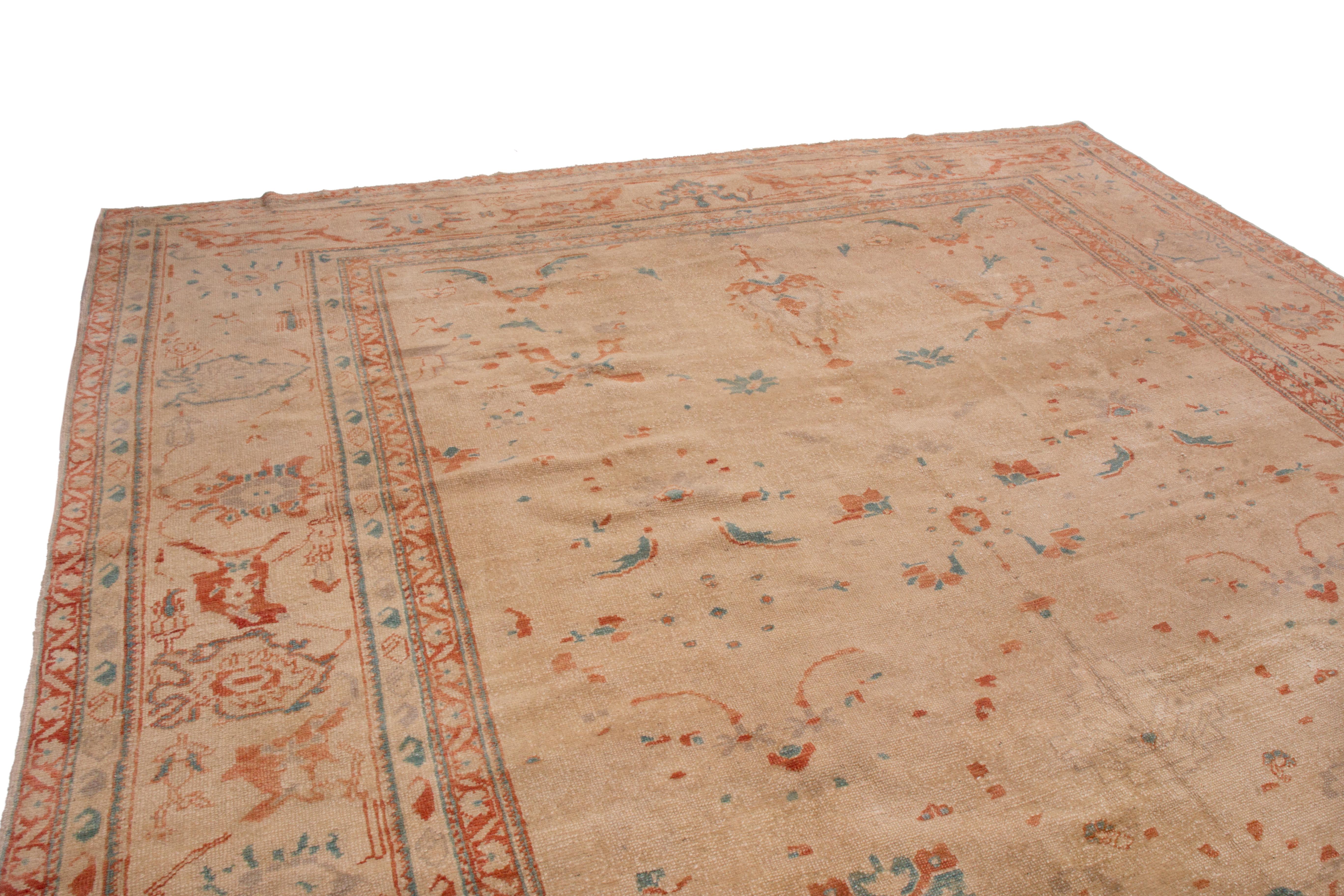 This transitional Sultanabad wool rug has an all-over geometric-floral pattern. From Turkey in 1980, the field has an almost open design like many Sultanabad families, though the thinner geometric-floral motifs are atypical. Marrying quiet hues of
