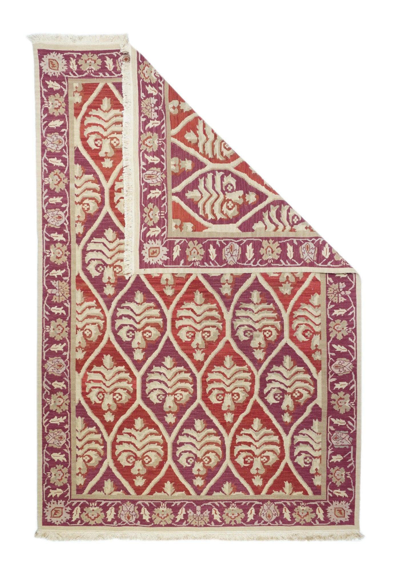 Sumak Rug 6'0'' x 9'0''. This recent Turkish creation shows an abrashed field in diagonal color bands, displayed in an ogival lattice enclosing uniformly vase and palm tree motives. Dark blue stencil palmette border. Weft-wrapping technique, no-pile