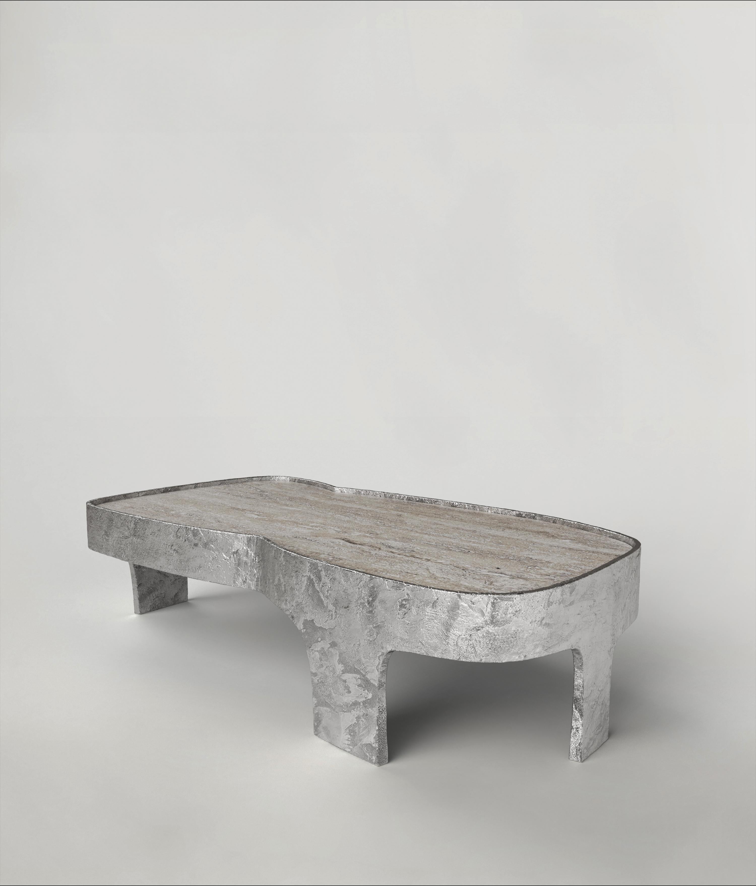 Sumatra V3 low table by Edizione Limitata
Limited Edition of 15 + 3 pieces. Signed and numbered.
Dimensions: D120 x W60 x H30 cm
Materials: Aluminum+ Travertine

Sumatra is a 21st Century collection of tables made by Italian artisans in aluminium