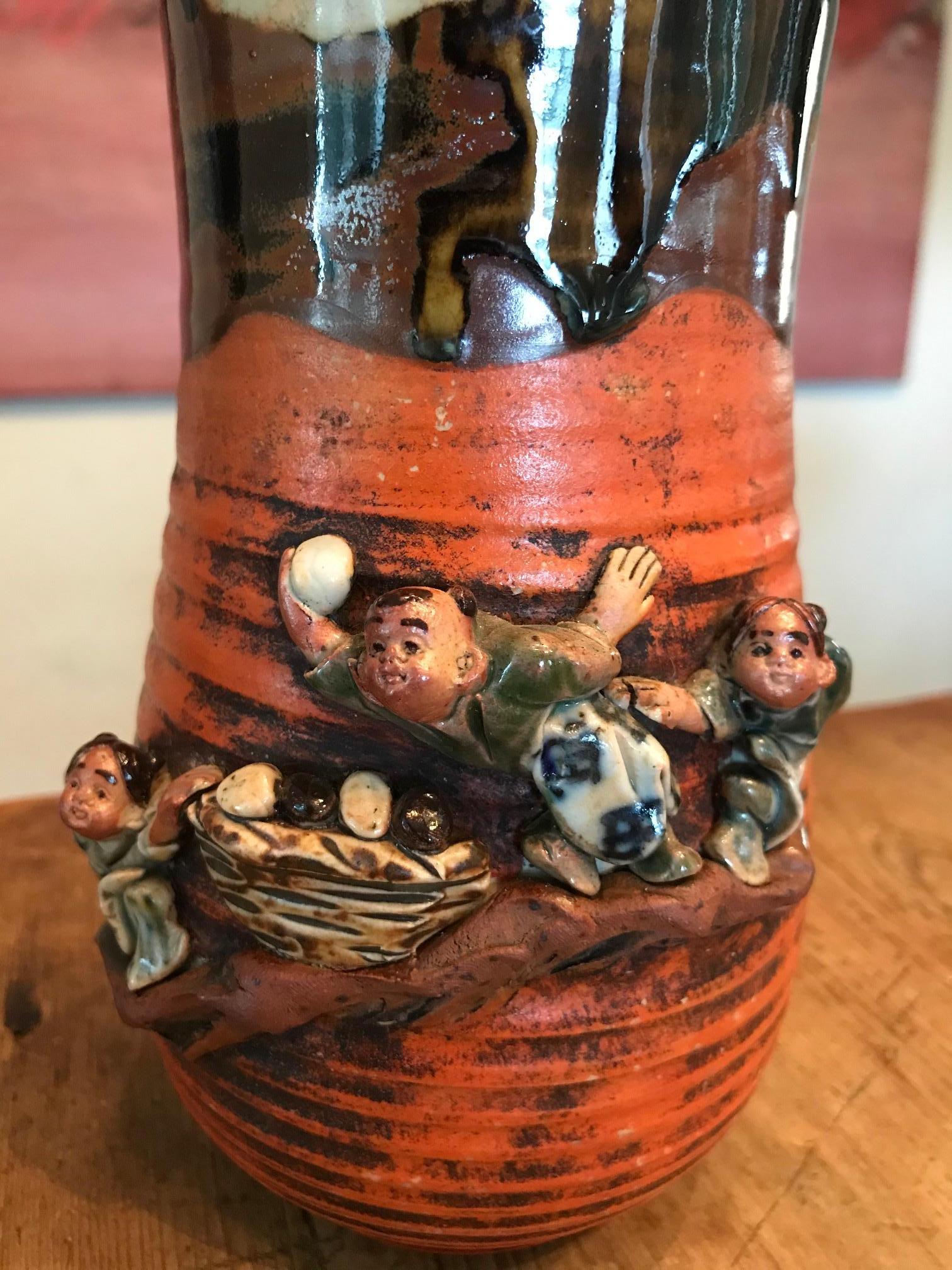 A fantastic Japanese Sumida Gawa vase, circa late 1800s-early 1900s depicting playing village children.

Signed on base.

Dimensions: 9