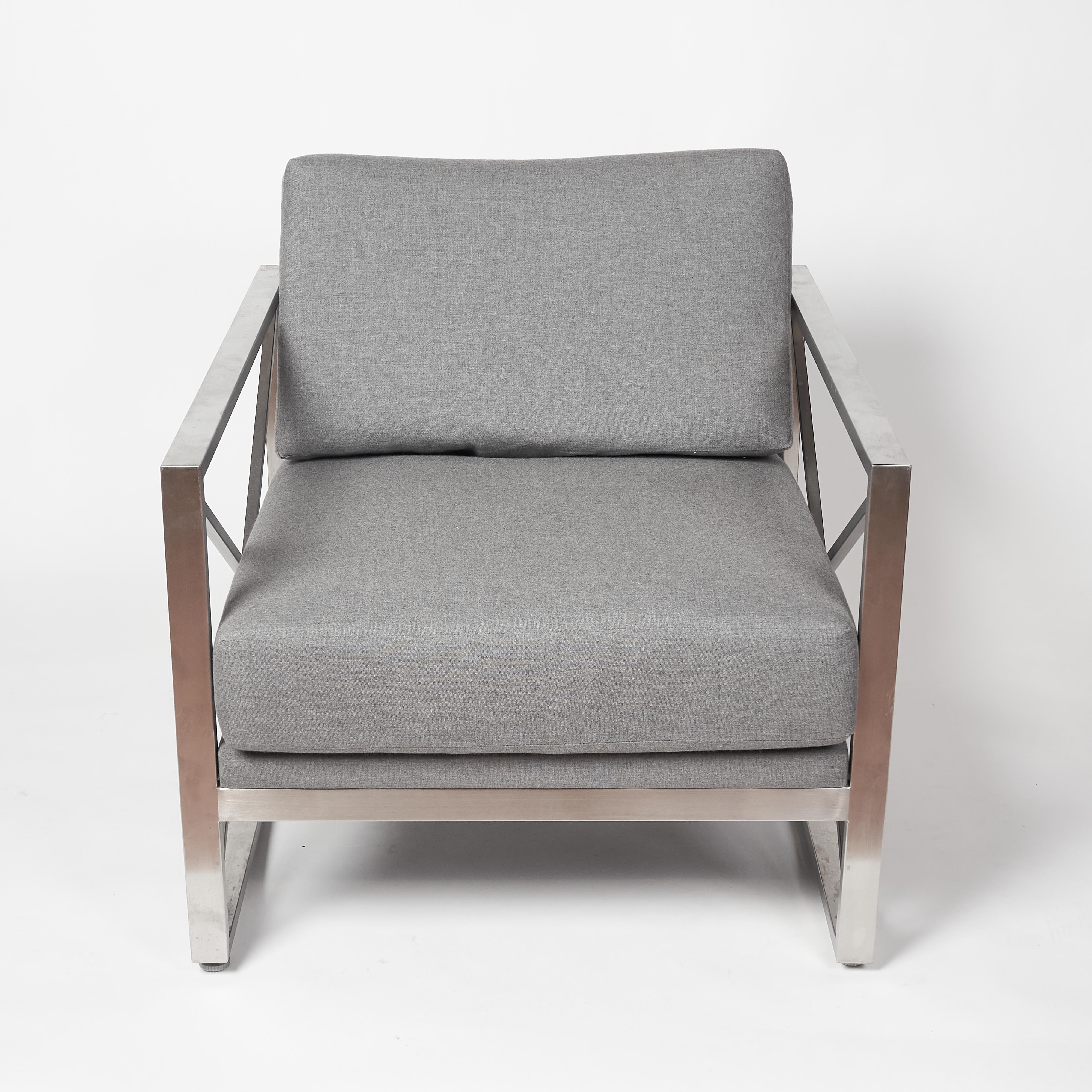 The Acero chair is constructed with a stainless steel frame, finished in cast slate. The cushions are covered in a medium gray Sunbrella fabric, which makes it perfect for any indoor and outdoor setting. With a sleek design, this piece will match