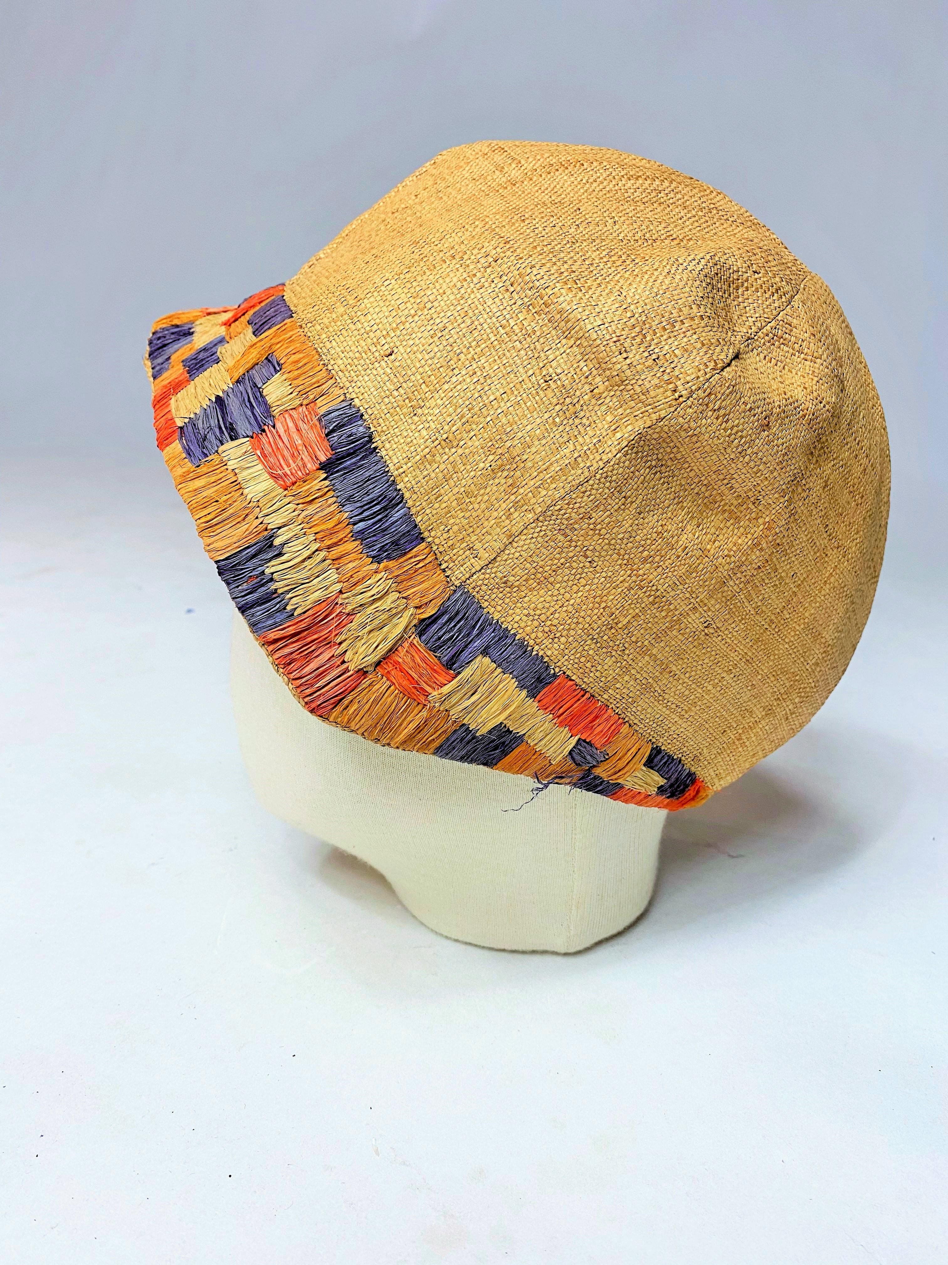 Circa 1925
Germany

Rare cloche hat or capote made of woven straw and colored Rafia embroidery dating from the Modernist Bauhaus period in Germany. Collected in Berlin. Interesting Cubist or Simultaneous graphics, a bit like what Sonia Delaunay and