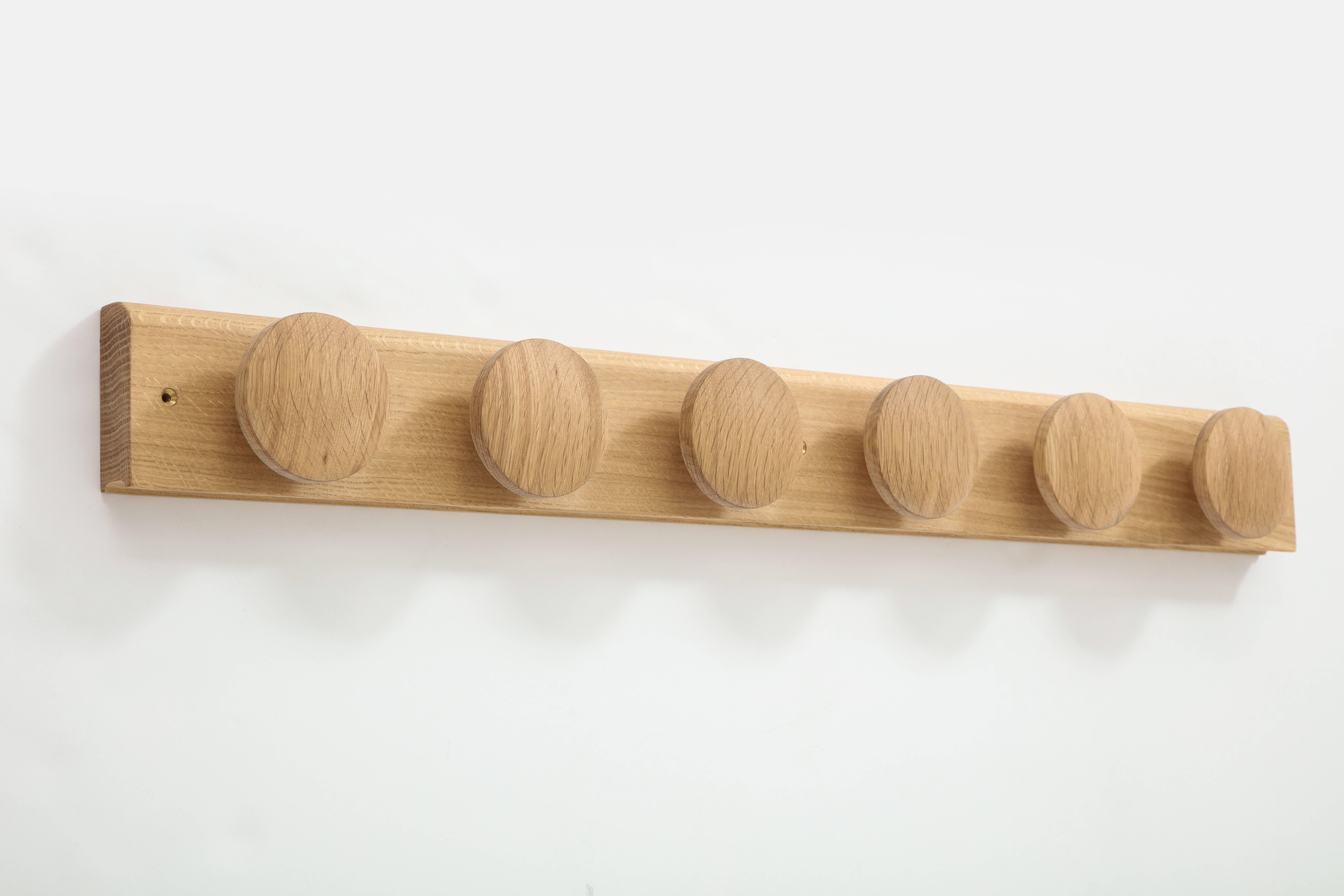 Mokume, a Japanese term for beauty of wood grain, is the design theme of this gorgeous and very functional coat rack. Six disc-shaped coat hooks in generous 4