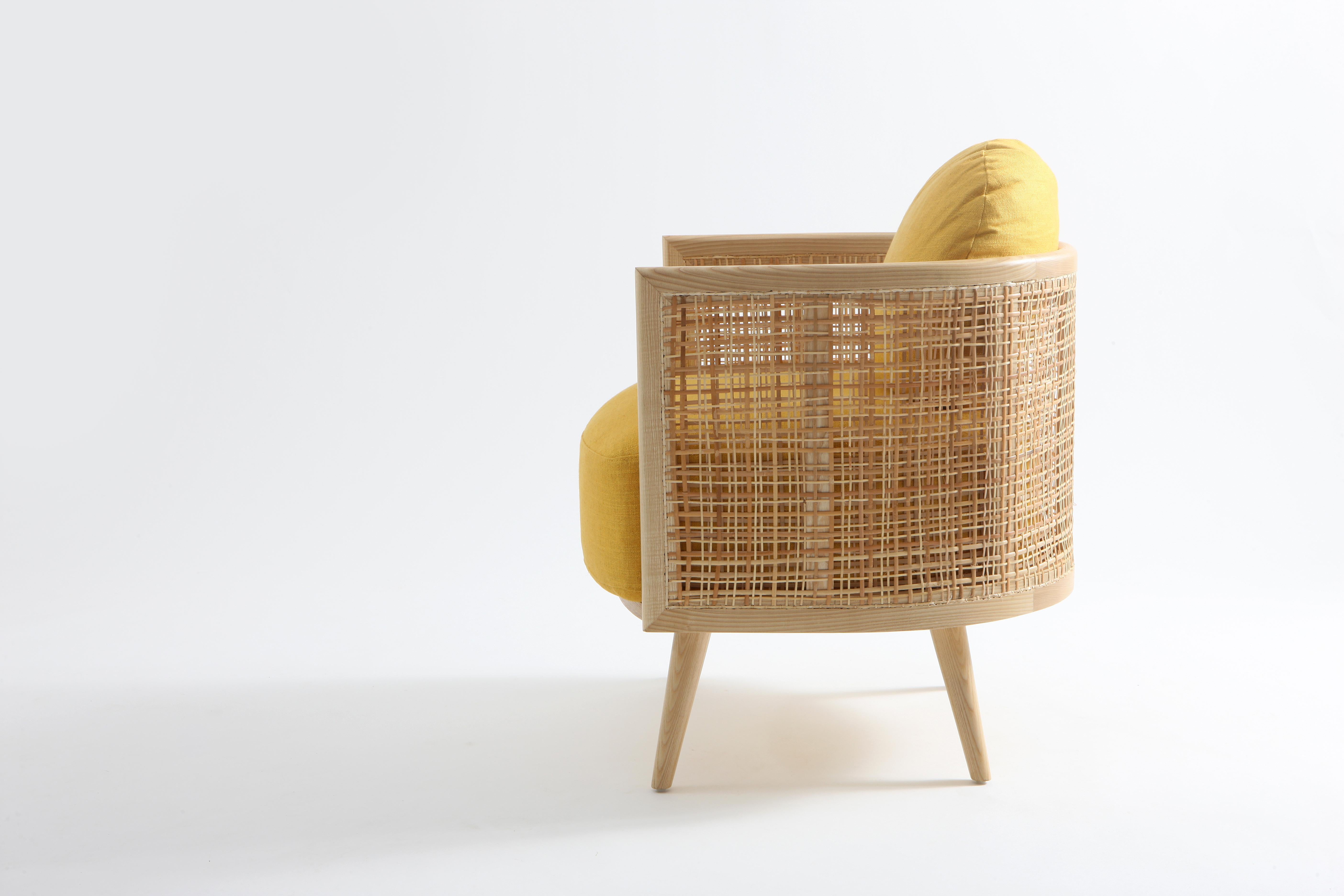 The Summerland armchair is crafted from solid ash wood with a textured straw weave back. A plush upholstered seat provides a high degree of seating comfort.