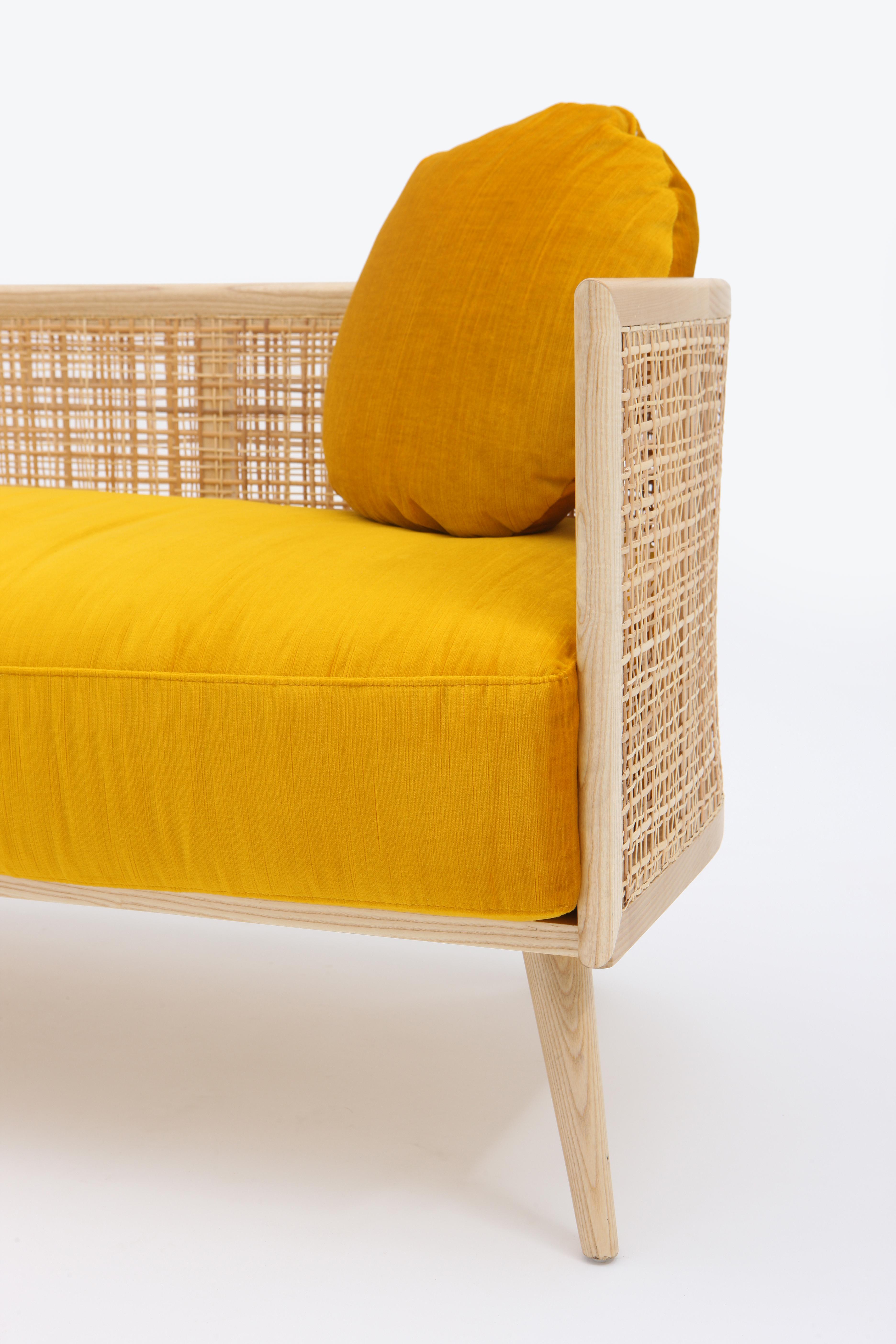 The Summerland sofa is crafted from solid ashwood with a textured straw weave back. A plush upholstered seat provides a high degree of seating comfort.