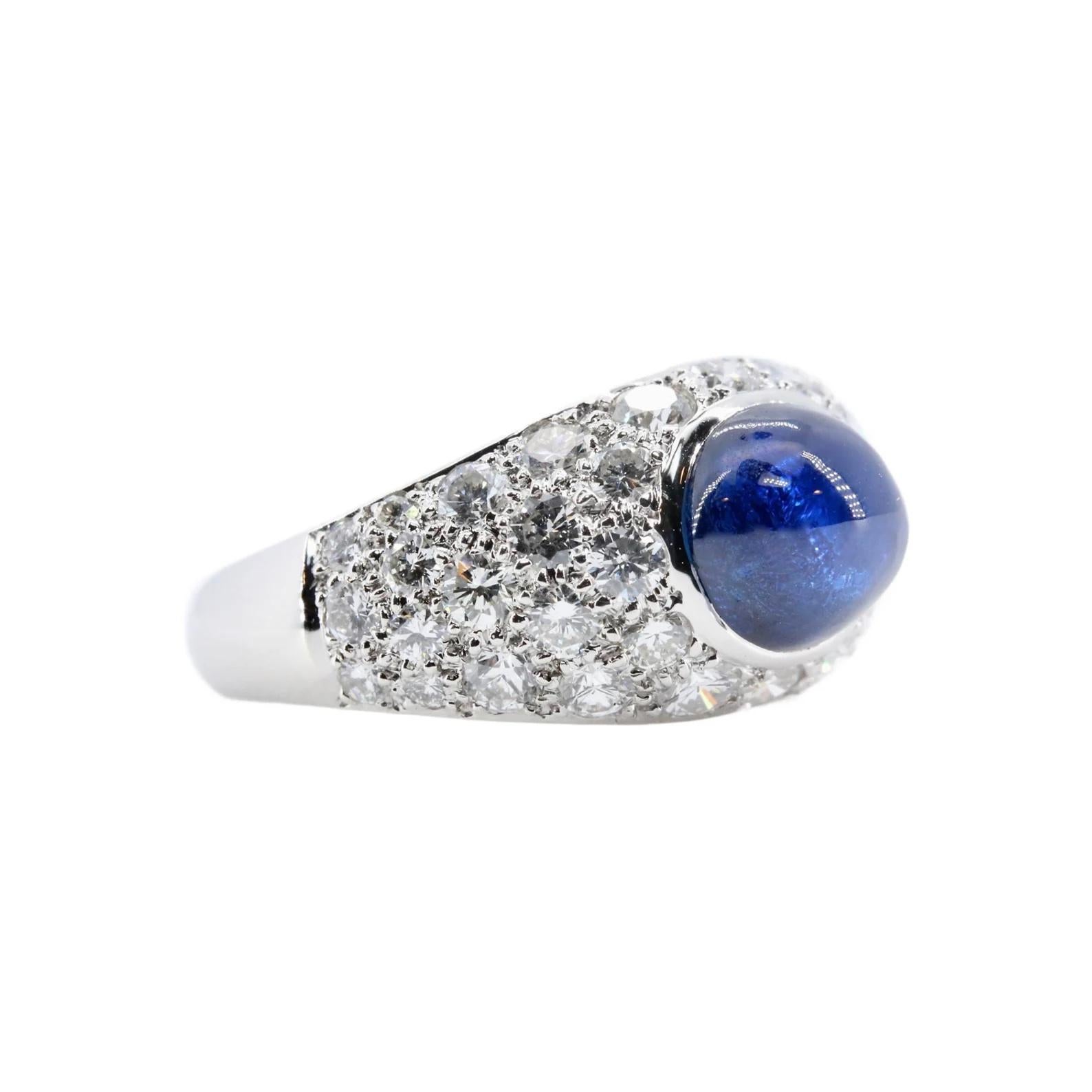 A sparkling mid century sapphire, and diamond cocktail ring in platinum. Centered by a cabochon cut oval Sapphire of approximately 3.25 carats with accompanying GIA report stating the sapphire is Heated only. Accenting the sapphire are 40 pave set