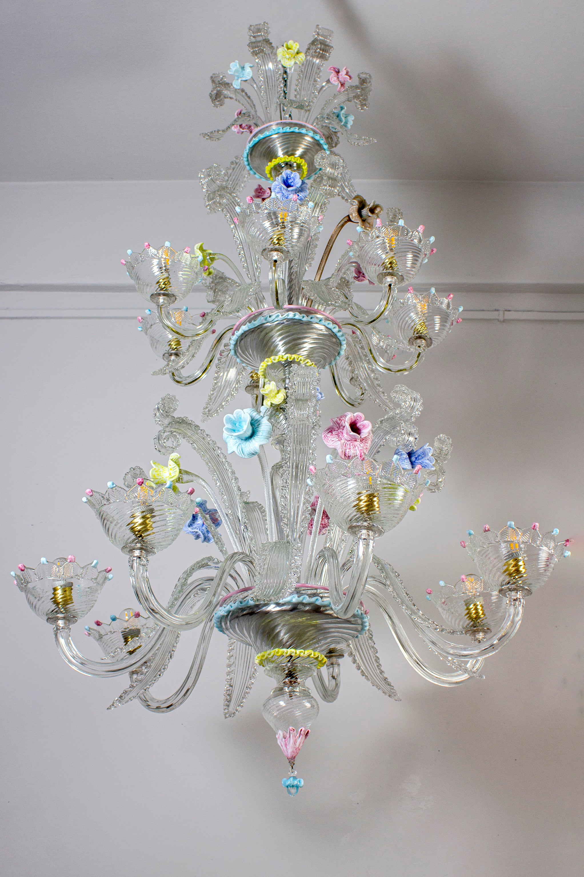 Spectacular Murano chandelier. The arms 14 are arranged on two floors. The glasses are embellished with colorful decoration  and amazing multicolor flowers. 
 14 light bulbs with 7 E27 and 7 E 14  or we can wire all  with E 14 candles.
 Timeless