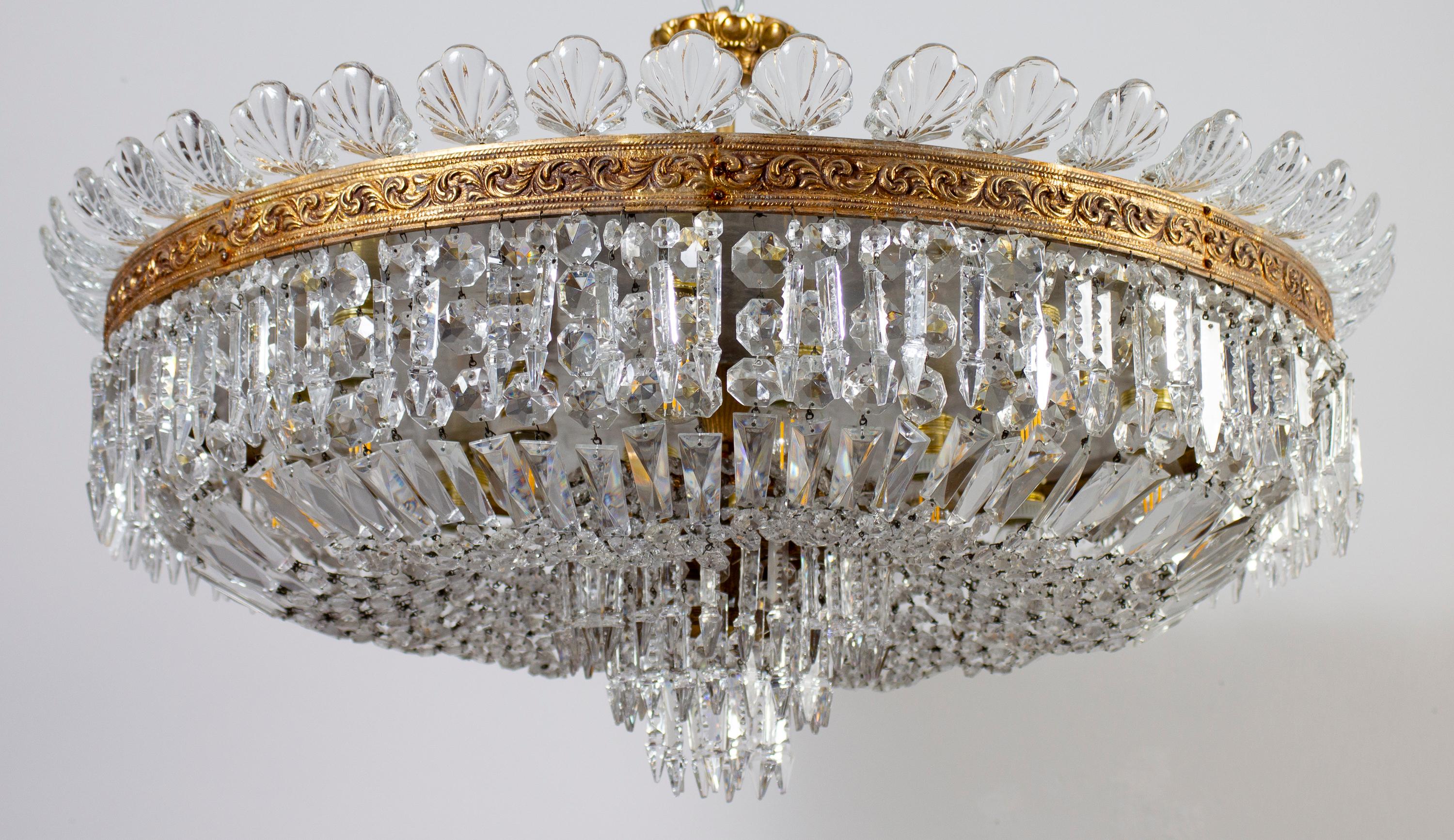 This Luxurious large and round shaped chandelier supporting a set of precious cut crystal prisms, octagons, oak leaves etc. 
Ideal for a large reception room, dining room or entrance hall centerpiece.
12 light bulbs E24.
Cleaned and re-wired, in