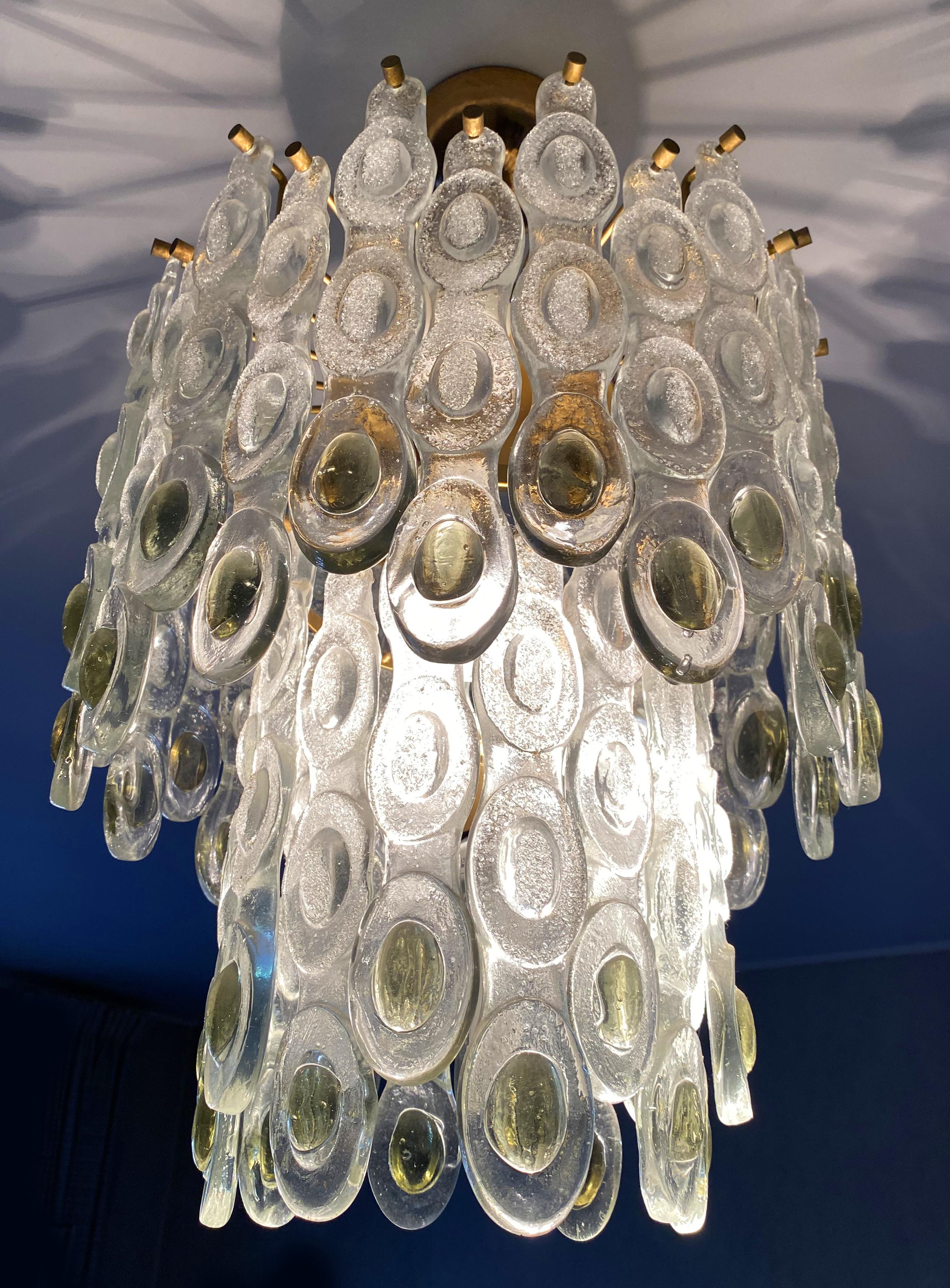 Incredibly elegant chandelier made up of dozens of lozenges. In each lozenge gems with golden inclusions are set. 7 lights.
