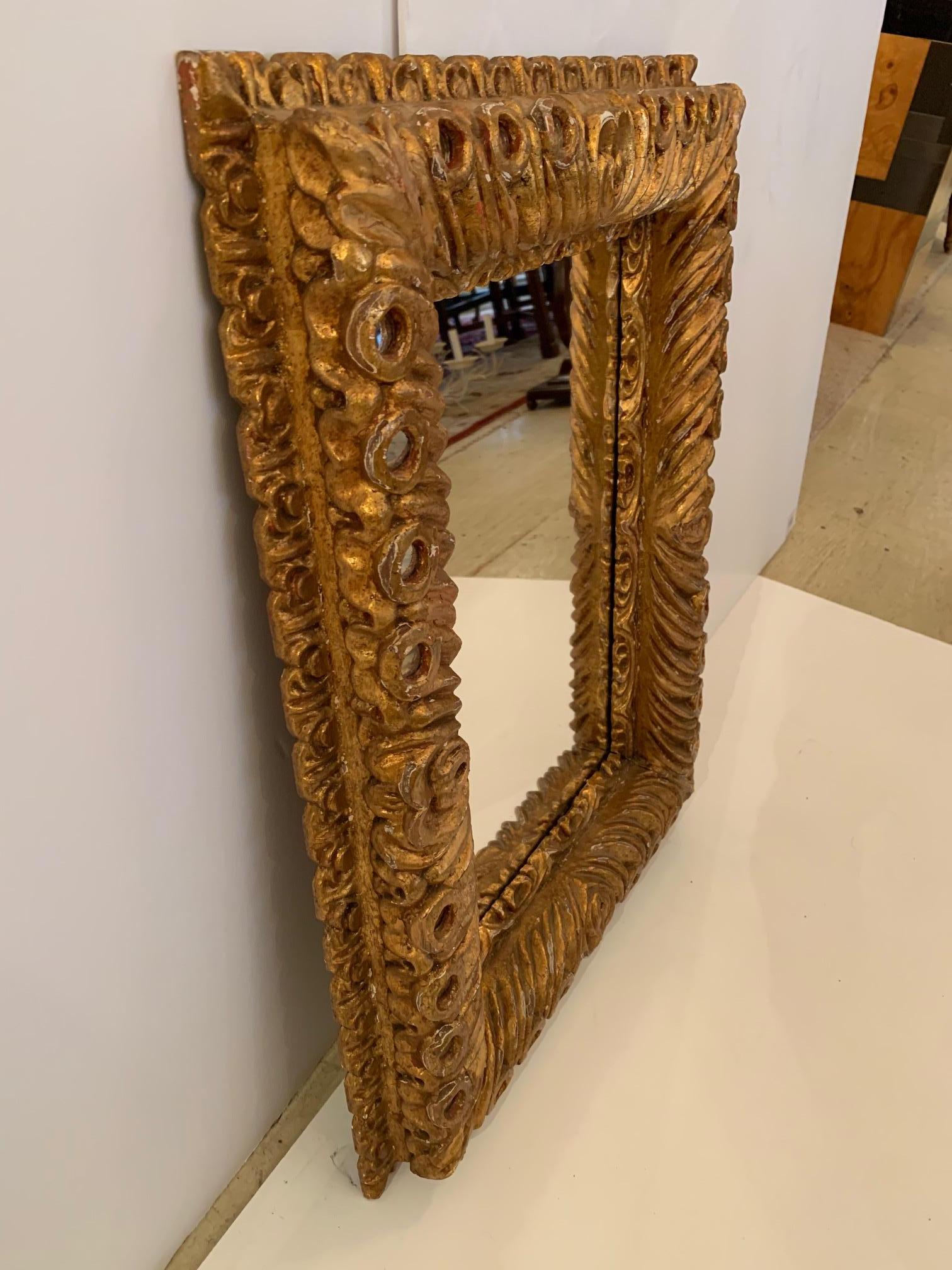 Sumptuous ornate Italian Rococo carved wood gold gilt mirror having decorative 
inset round mirror pieces around the periphery.

 