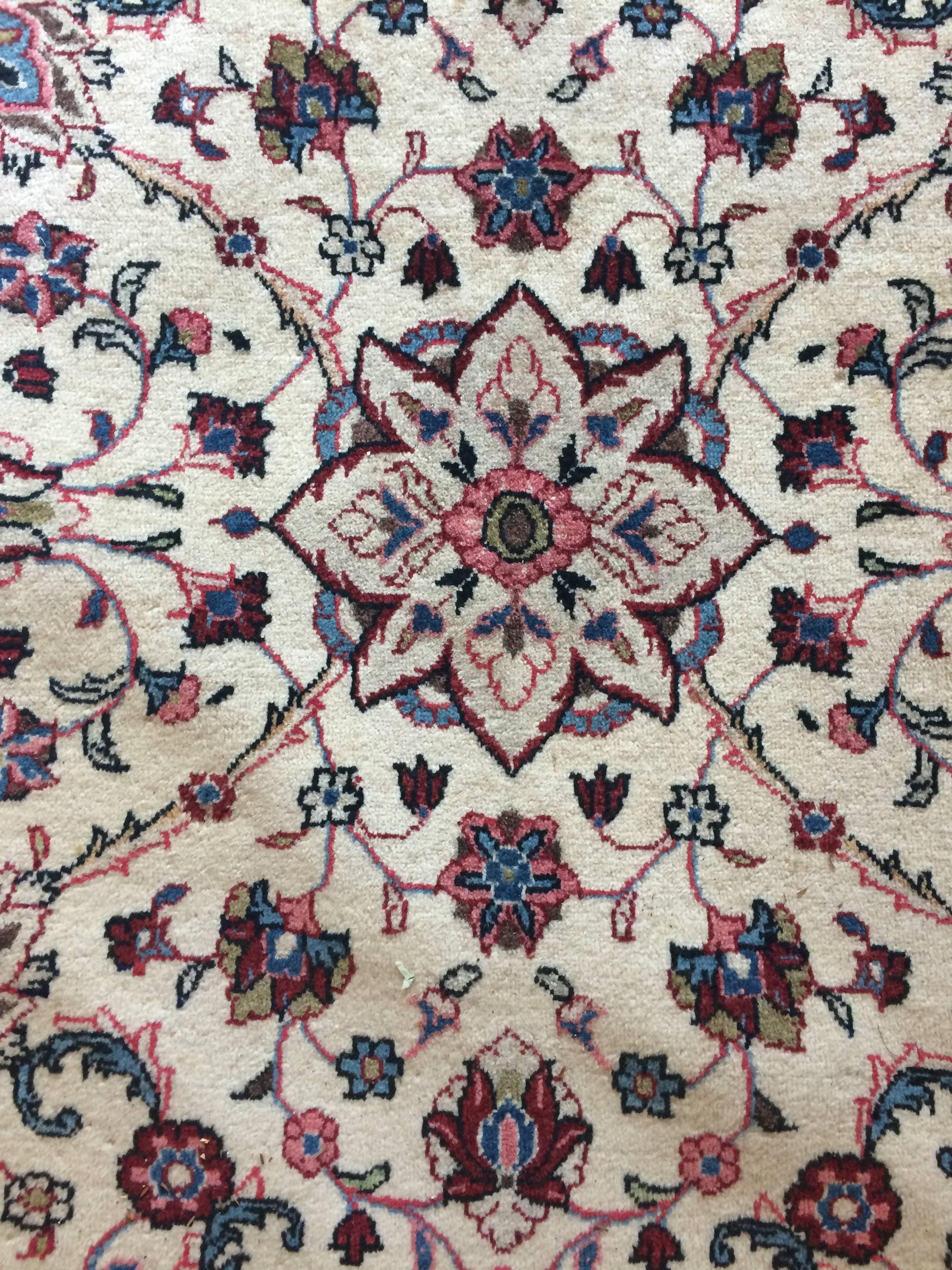 Beautiful Pakistani Isfahan wood rug having a Classic pattern in blue, cranberry, pink and tan against a cream background. Rich decorative border around the periphery and great craftsmanship. Leather binding around back periphery for extra support.