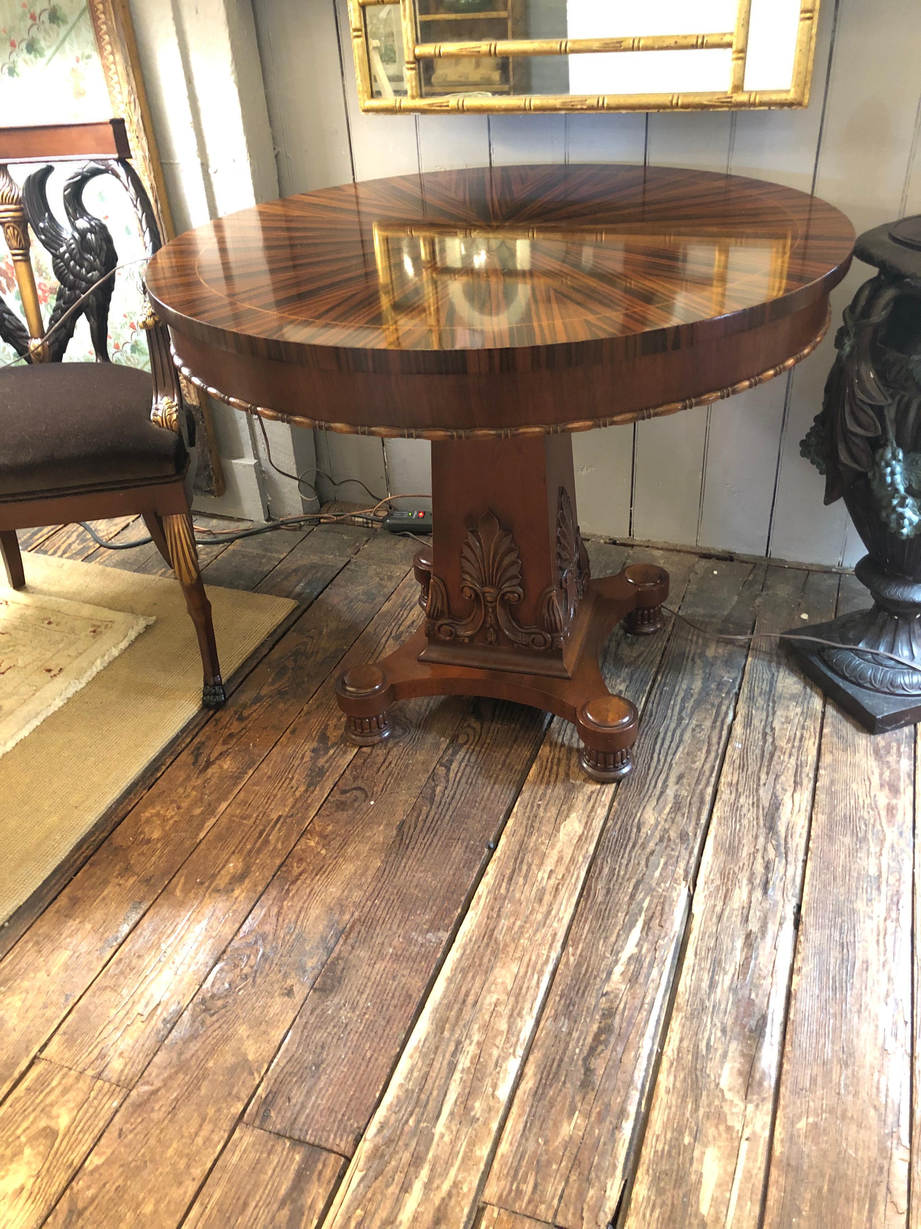 Round center pedestal dining or side table having sunburst pattern ebony mahogany and satinwood veneer top and decorative plumes on the pedestal.  Apron 25.5 h