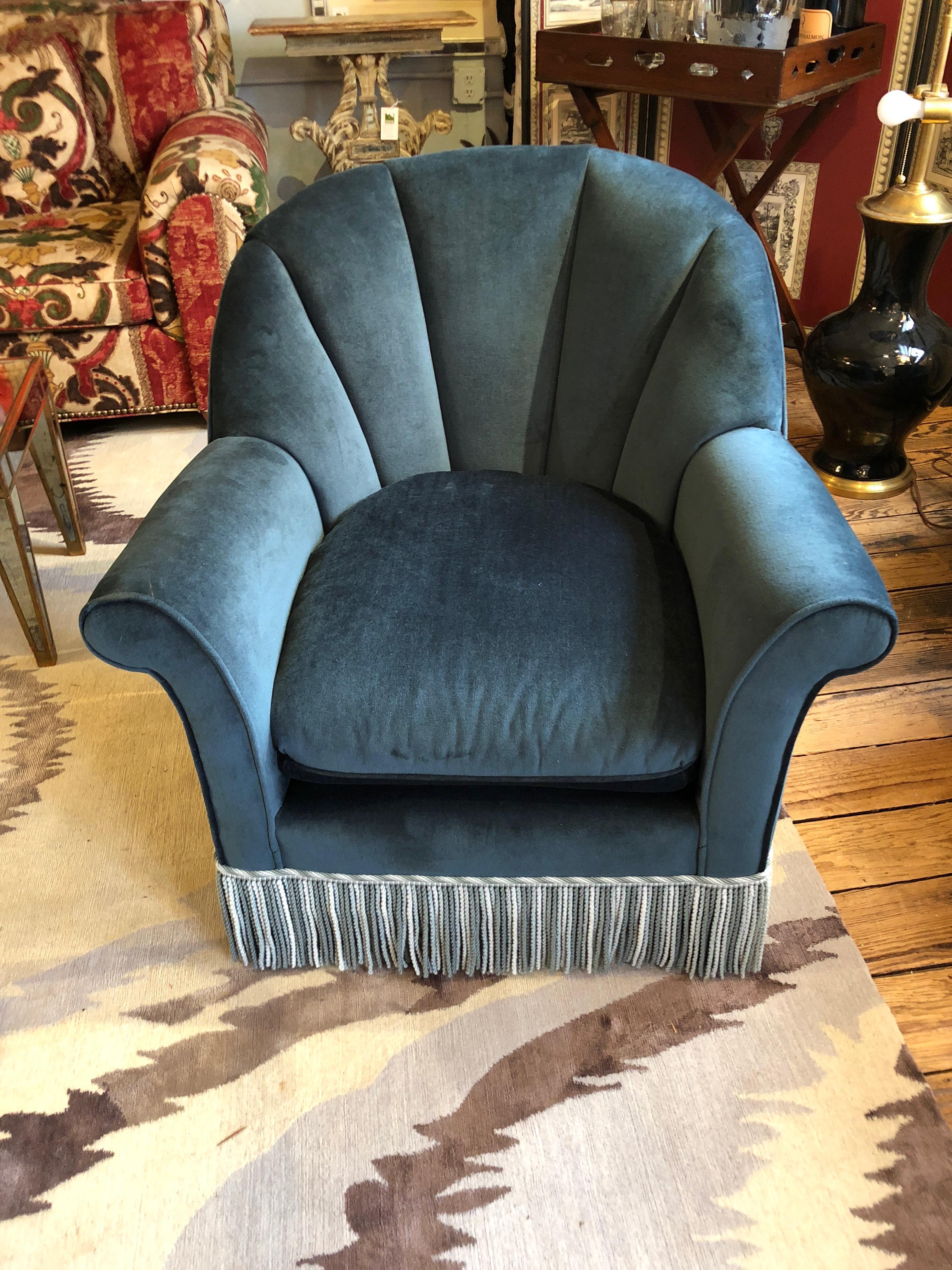 Luxurious blue velvet curvy comfy club chairs having channel backs, removable seat cushions and finished with elegant blue and cream buillion fringe. There's a matching single ottoman included.
Measures: Ottoman height 18, width 26, depth 21.