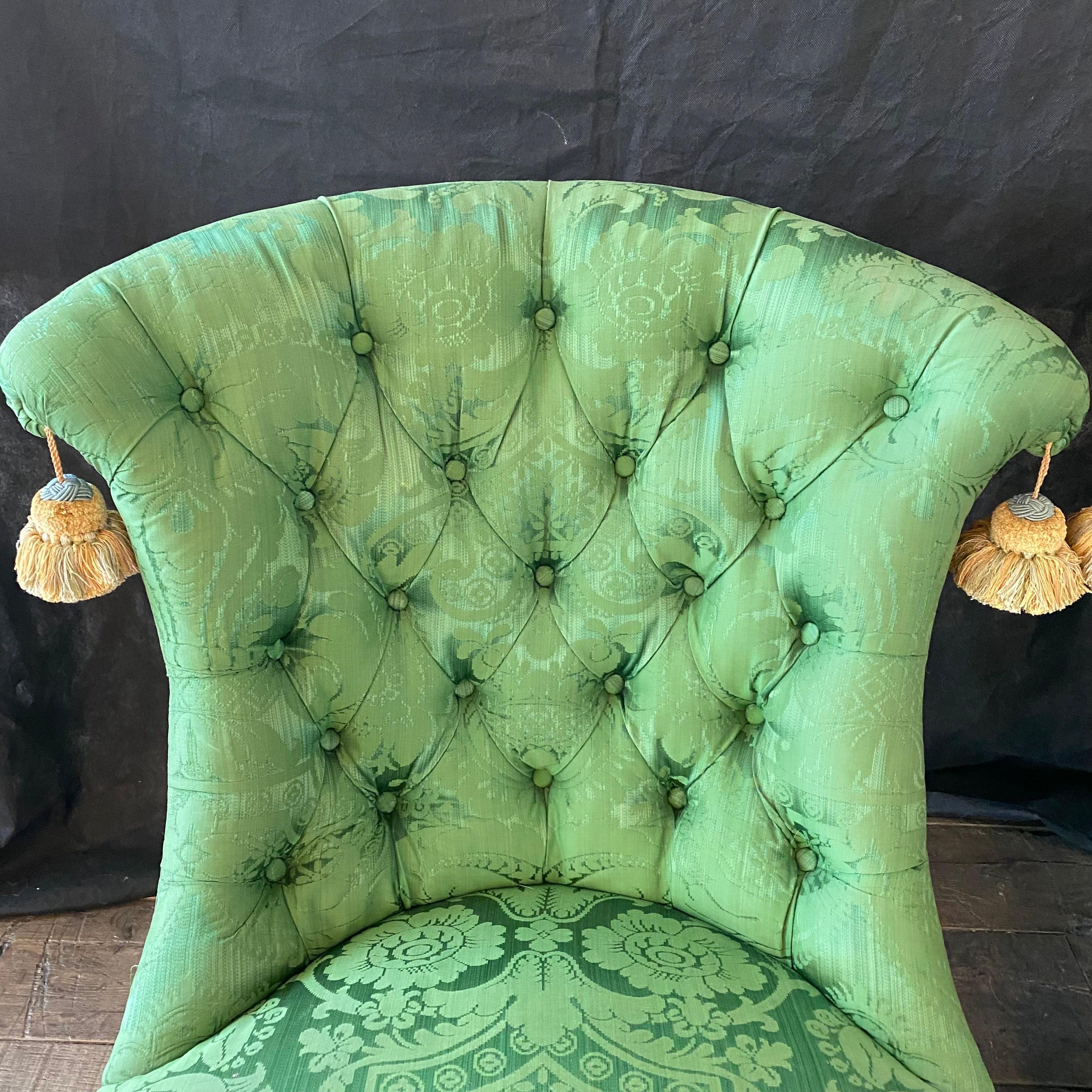 Sumptuous French Napoleon III green silk tufted back slipper chair with ebony turned legs, having a gold fringed trim. Mild sun bleaching on back; priced accordingly   #5648 

 