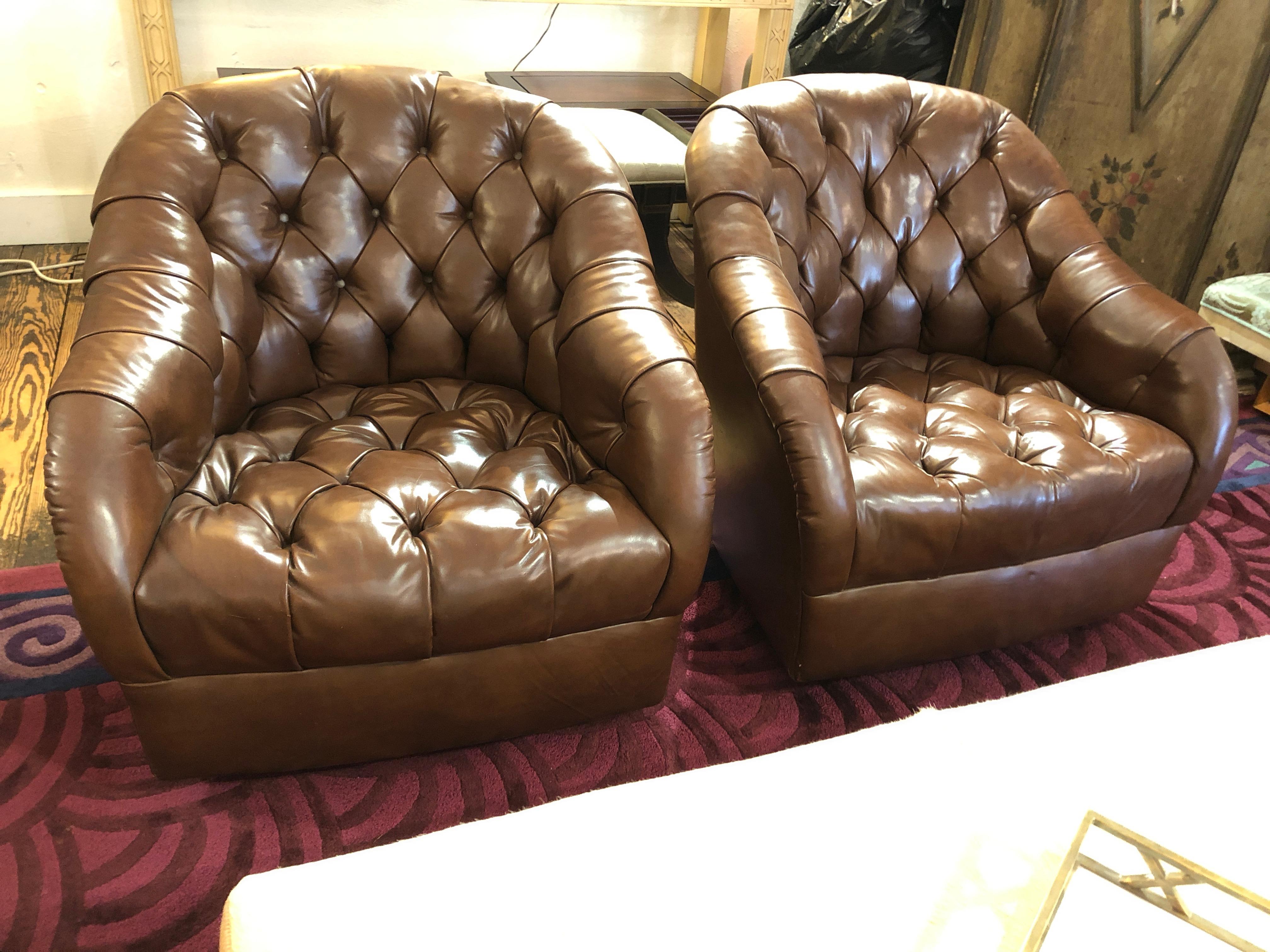 Two to die for elegant barrel back swivel lounge chairs with deep button tufting and original handstitched milk chocolate brown leather upholstery. Even the swivel underneath is leather clad. By Ward Bennett, label underneath.
Measures: Seat height