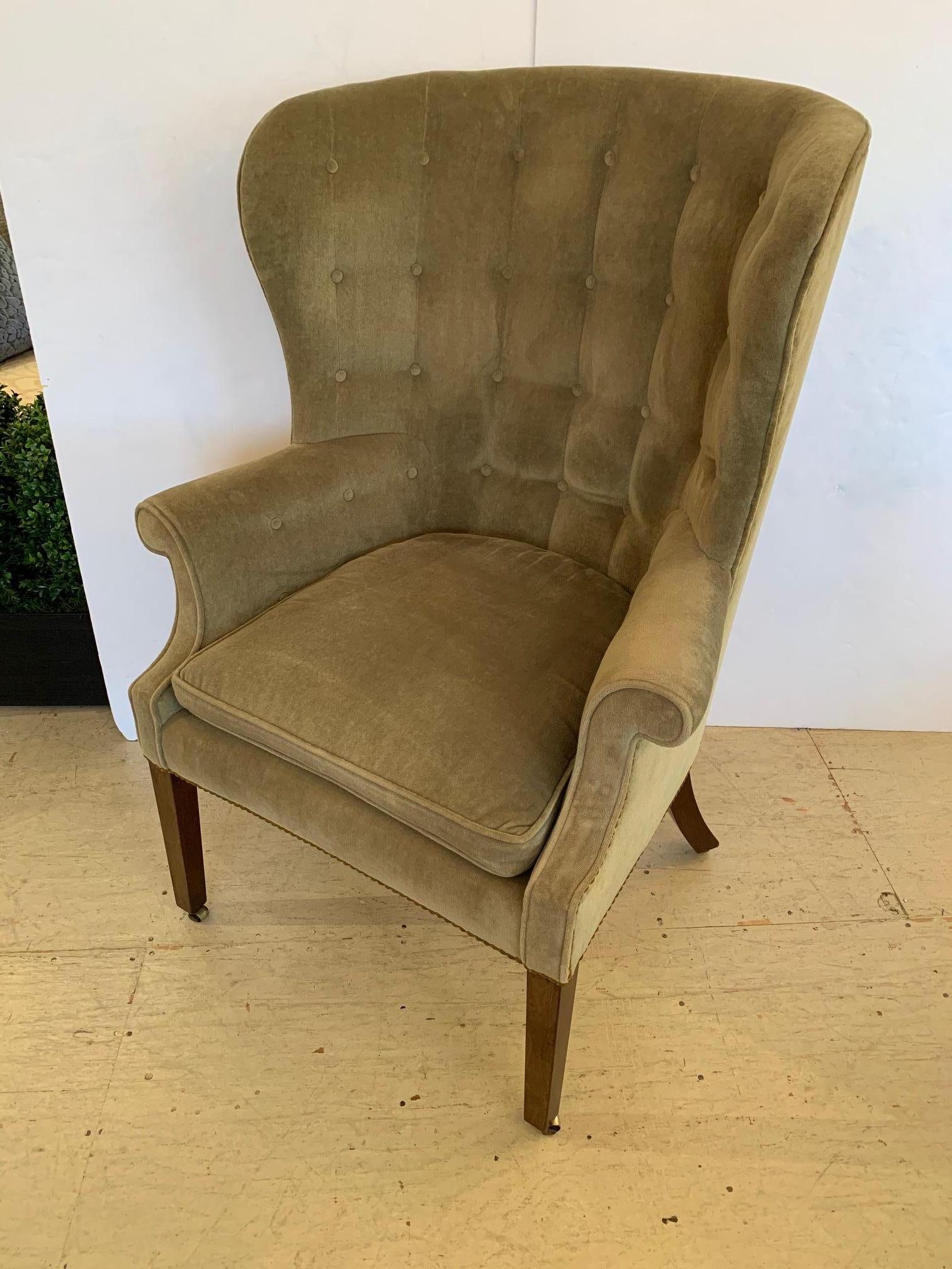Elegant vintage tufted barrel back wing club chair upholstered in sumptuous sage green velvet and finished with brass nailheads. Mahogany legs are tapered and terminate in brass casters.
Measures: Arm 27 H
Seat 22 D.