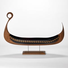 Sun, a cut steel blue glass & oak viking ship by Backhaus & Brown and Egeværk