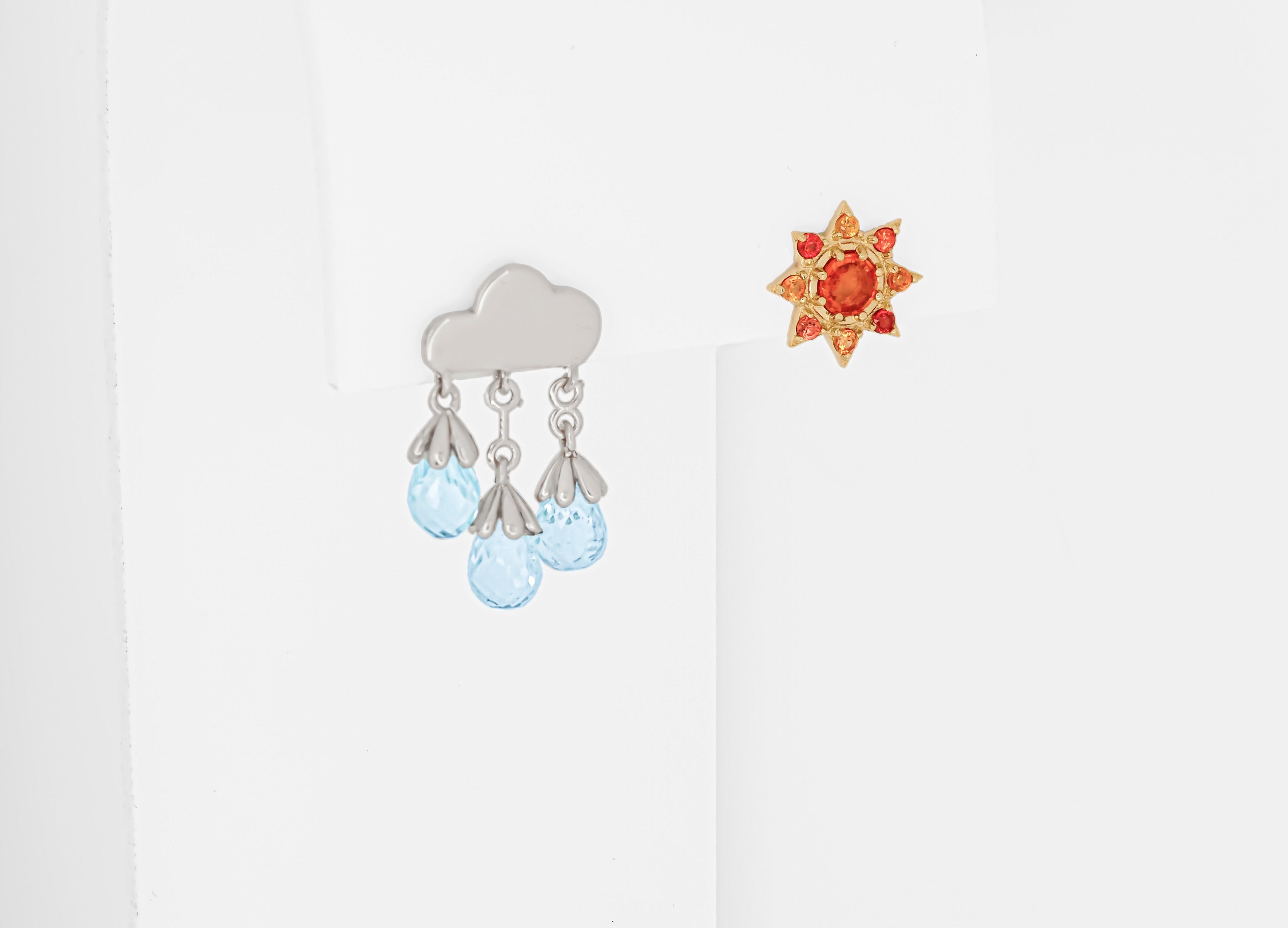 Sun and rain cloud 14 karat gold earrings studs. Orange sapphire studs. Mismatched Sun and Rain Cloud  Earrings.  Contemporary design earrings.

14 kt solid yellow and white gold. September birthstone. November birthstone.
Weight: 3.10 g. 
1. Rain