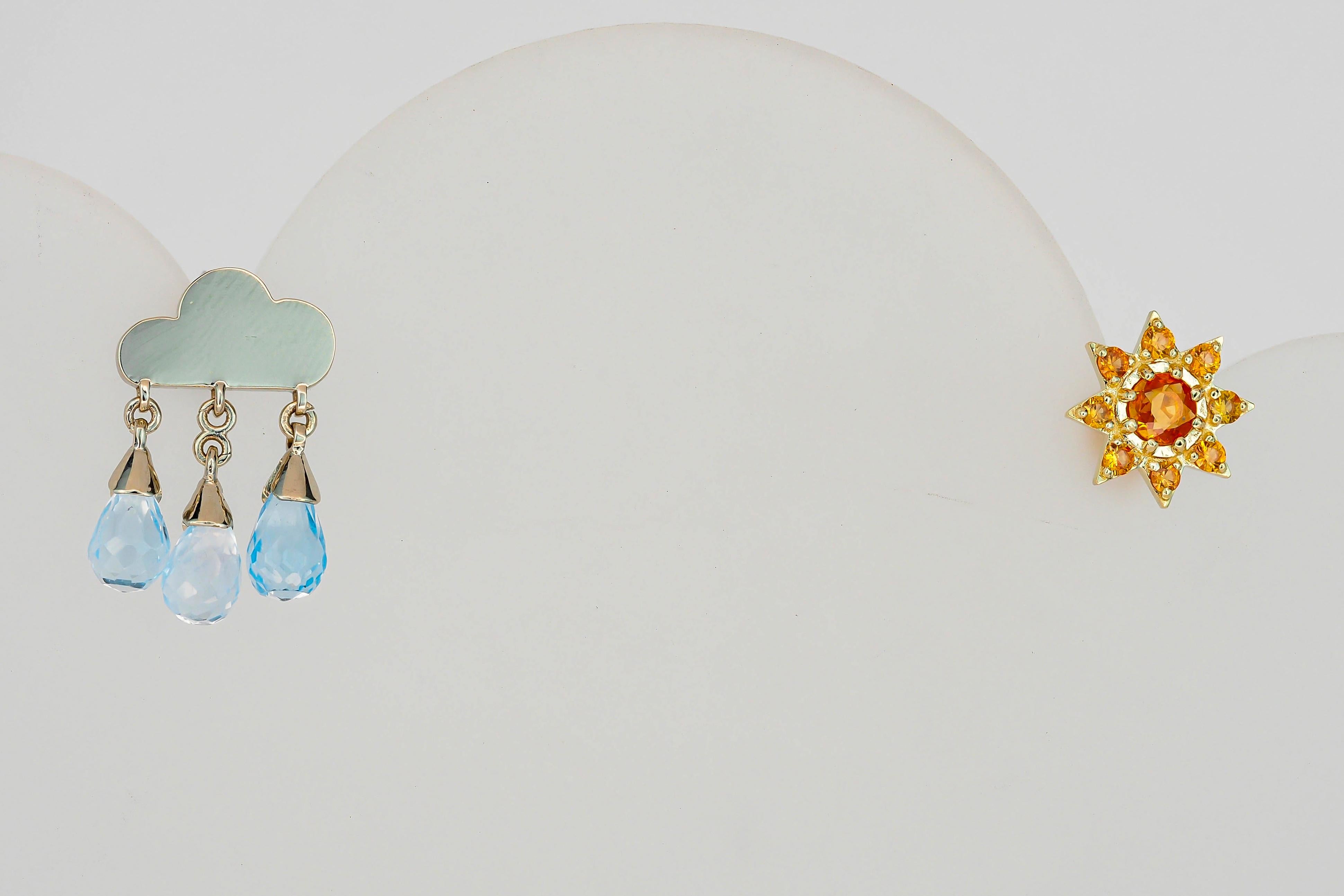 Sun and rain cloud 14 karat gold earrings studs. Orange sapphire studs. Mismatched Sun and Rain Cloud  Earrings.

14 kt solid yellow and white gold. September birthstone. November birthstone.
Weight: 3.10 g. 
1. Rain cloud:
Solid white 14k gold.