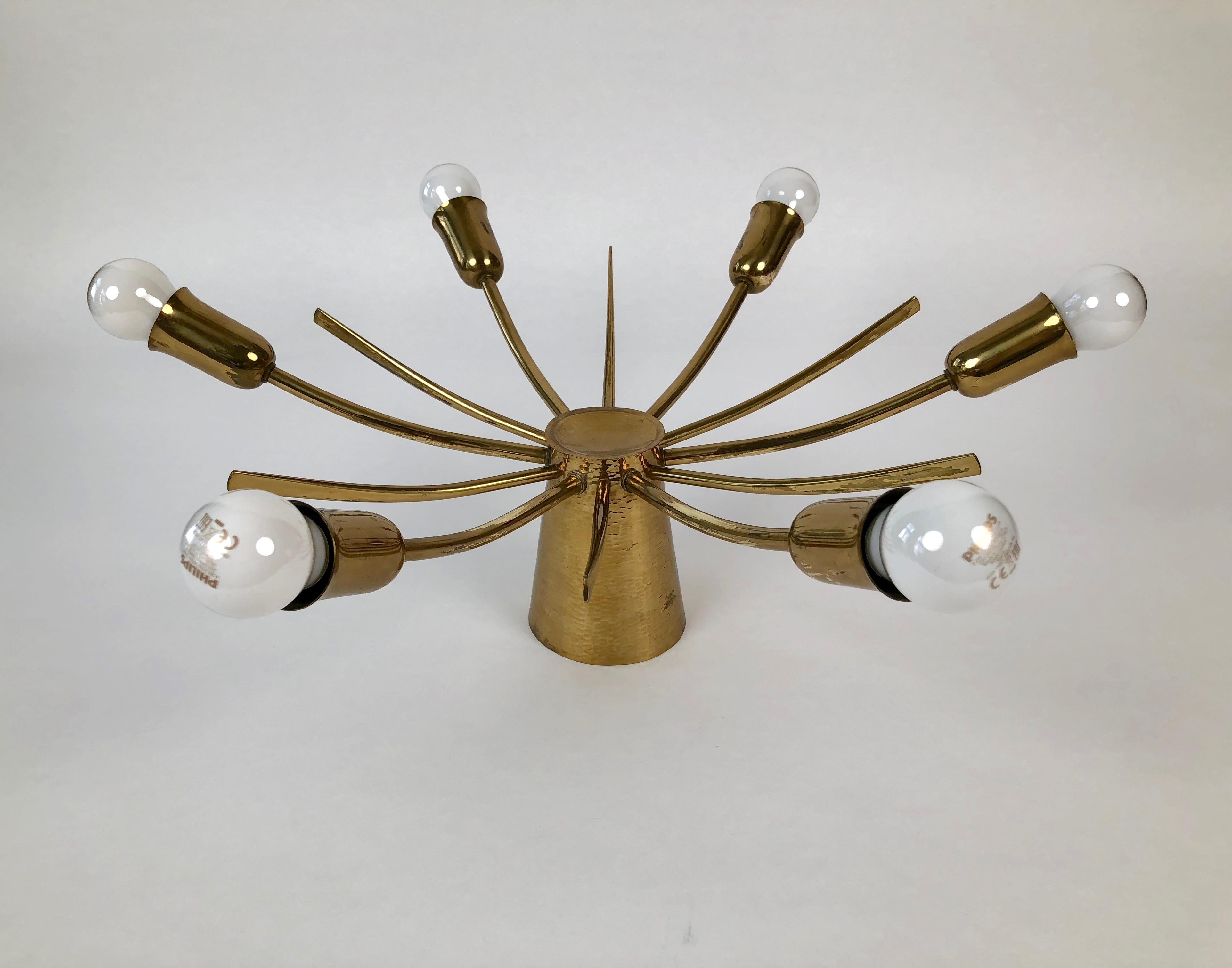 This sun ceiling lamp made in solid brass with a hand hammered cone features 6-light bulbs (40 Watt).
Made in France, circa 1950.