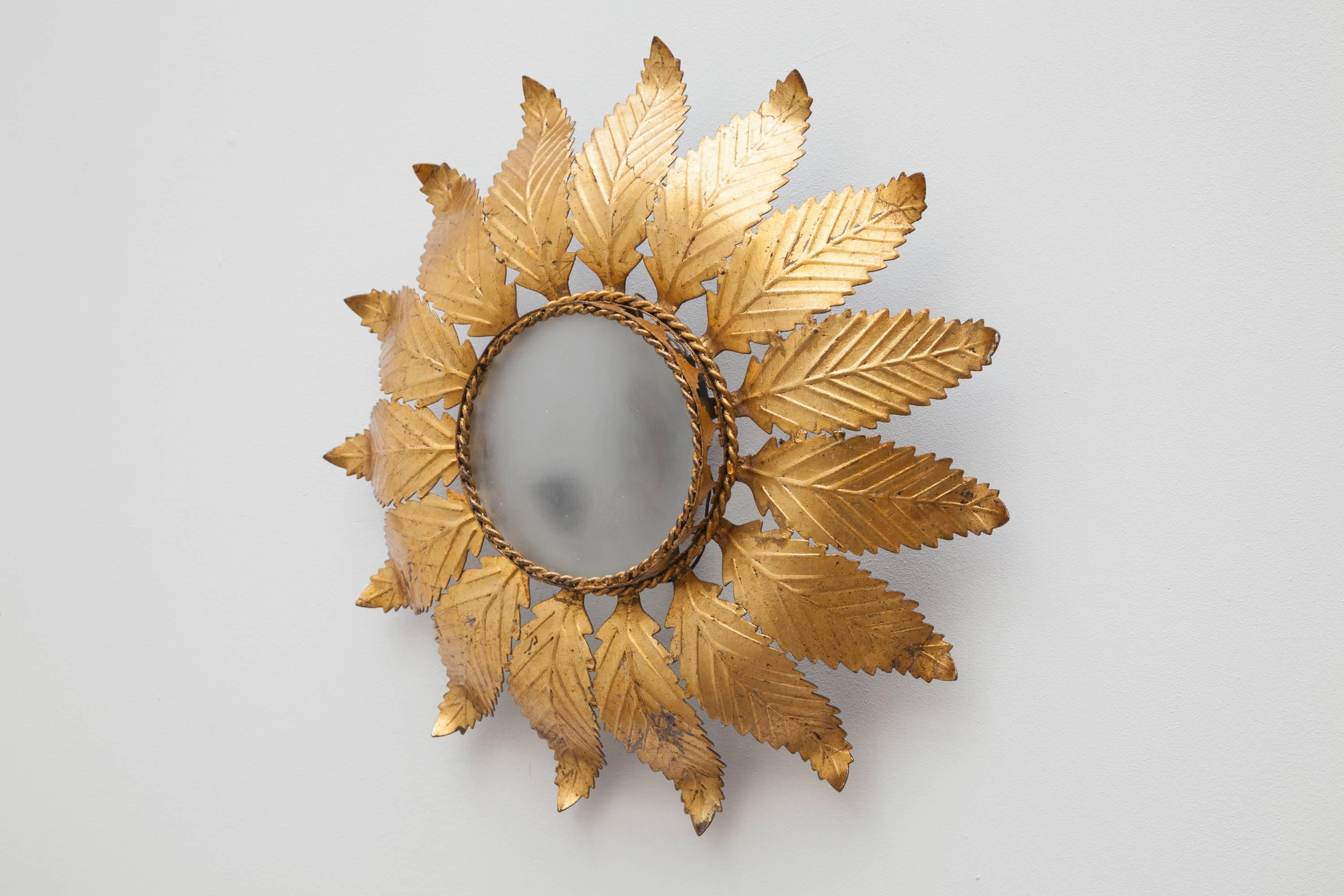 Surrealist sun with a hammered brass face designed in the 1950s, this beautiful fixture has two lights that illuminate the
glass delightful with the floral gold leafs.