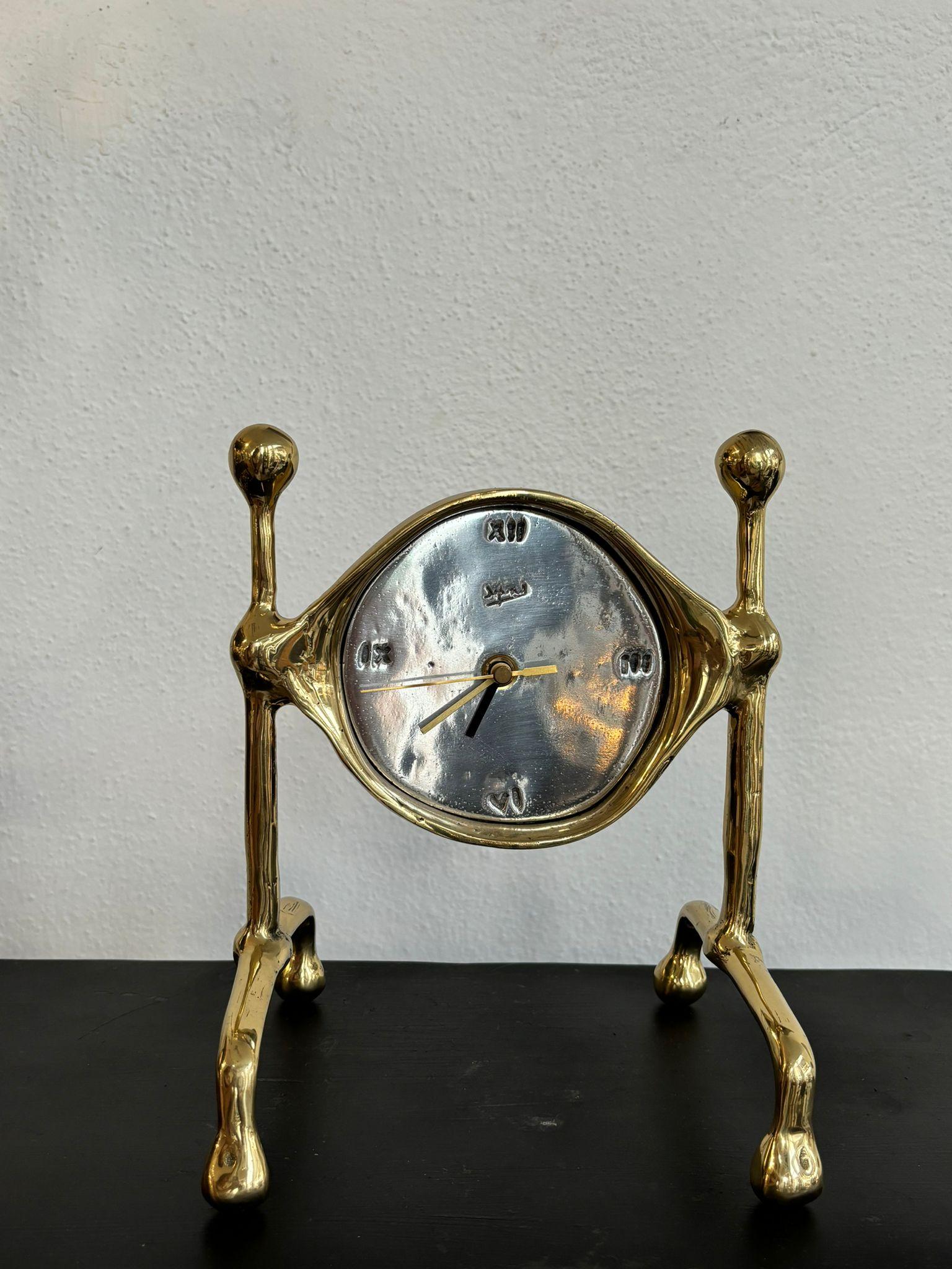The Sun Clock was created by David Marshall, from sand cast aluminium and brass.
 We use recycled materials all our pieces are handmade, mounted and finished in our foundry and workshop in Spain.
It is certified authentic by the Artist David