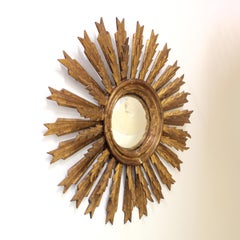 Sun Mirror with convex moon in a carved and gilded wooden frame