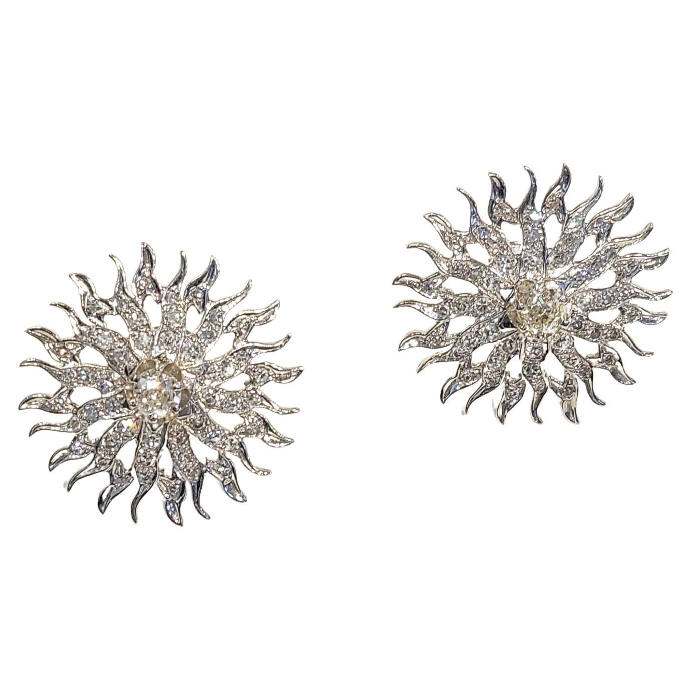Sun Motif Old Mine Diamond Earrings

A pair of 14-karat white gold earrings featuring a sun motif, set with 2 central old mine diamonds weighing approximately 1.39 carats, accented by an additional 2.4 carats of diamonds

Diameter: 1.25