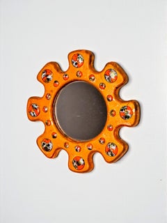 Sun shaped Modernist enamel mirror by J. Capo Esmaltes, Spain, 1970's