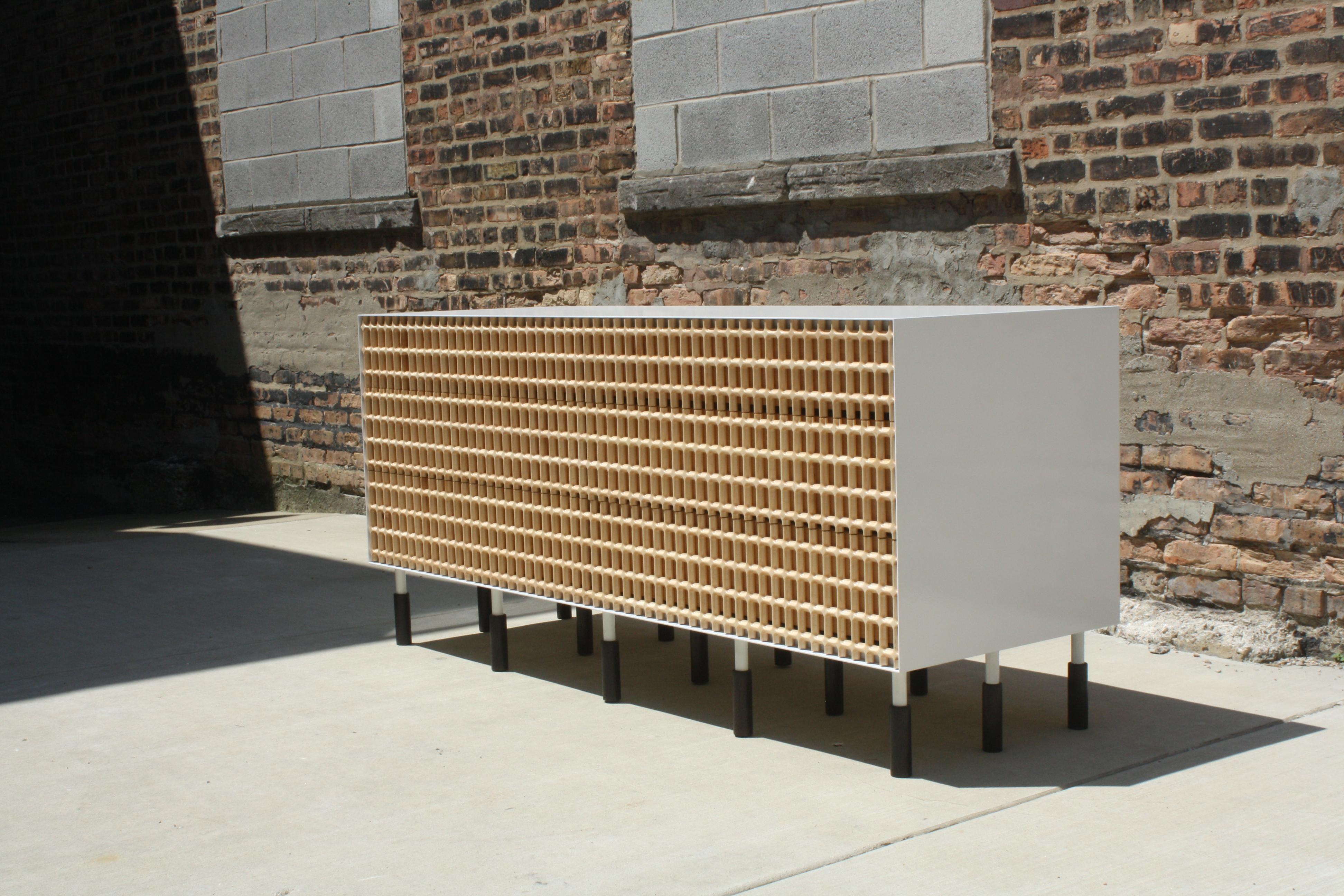 Carved maple lattice, white enameled steel, and oxidized walnut

6 drawers, measures: 72” W x 32” H x 24” D

Inspired by brise-soliel, an architectural feature designed to break the sun by casting shadows, we set out to reference this at