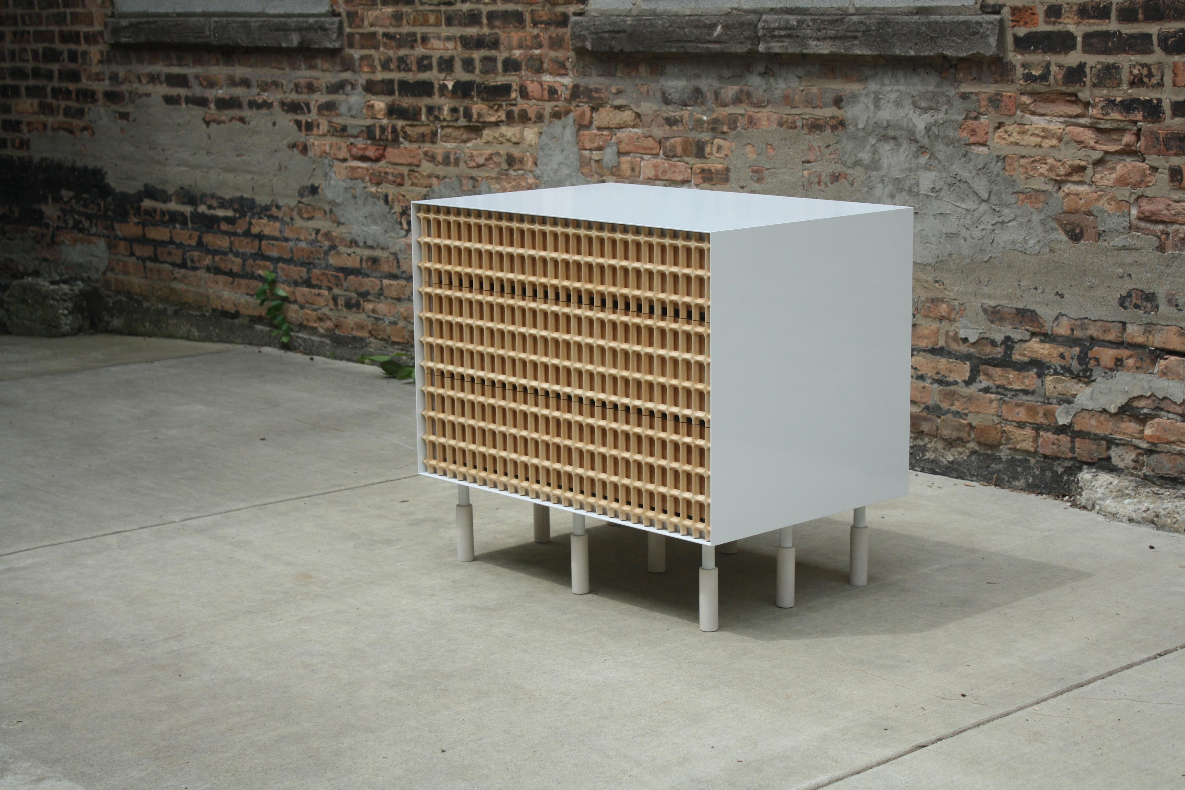 Carved natural maple lattice and drawers, gloss white powder-coated steel, and bleached maple legs

shown with:
2 drawers, measures: 24