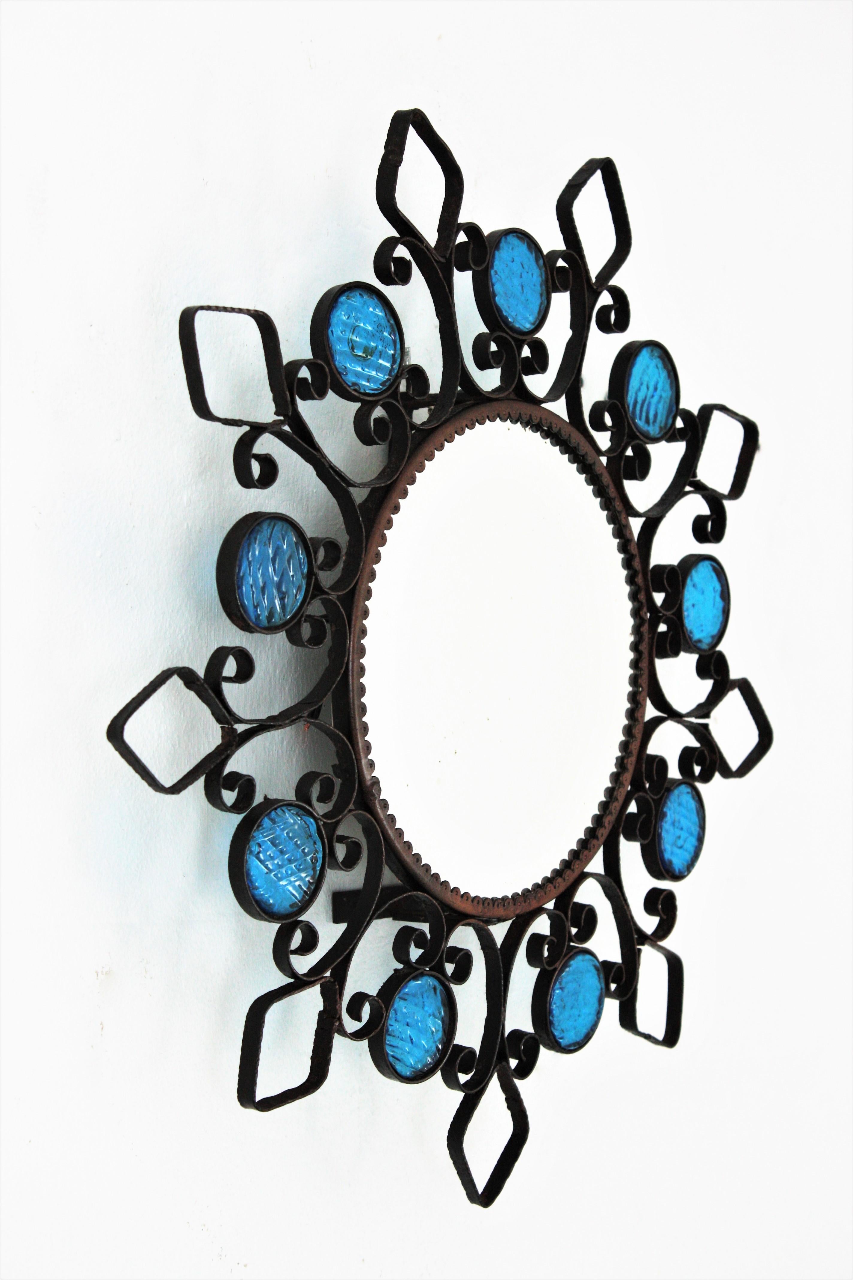 Spanish Backlit Iron Sunburst Mirror / Wall Light Fixture with Blue Glass Details, 1950s For Sale