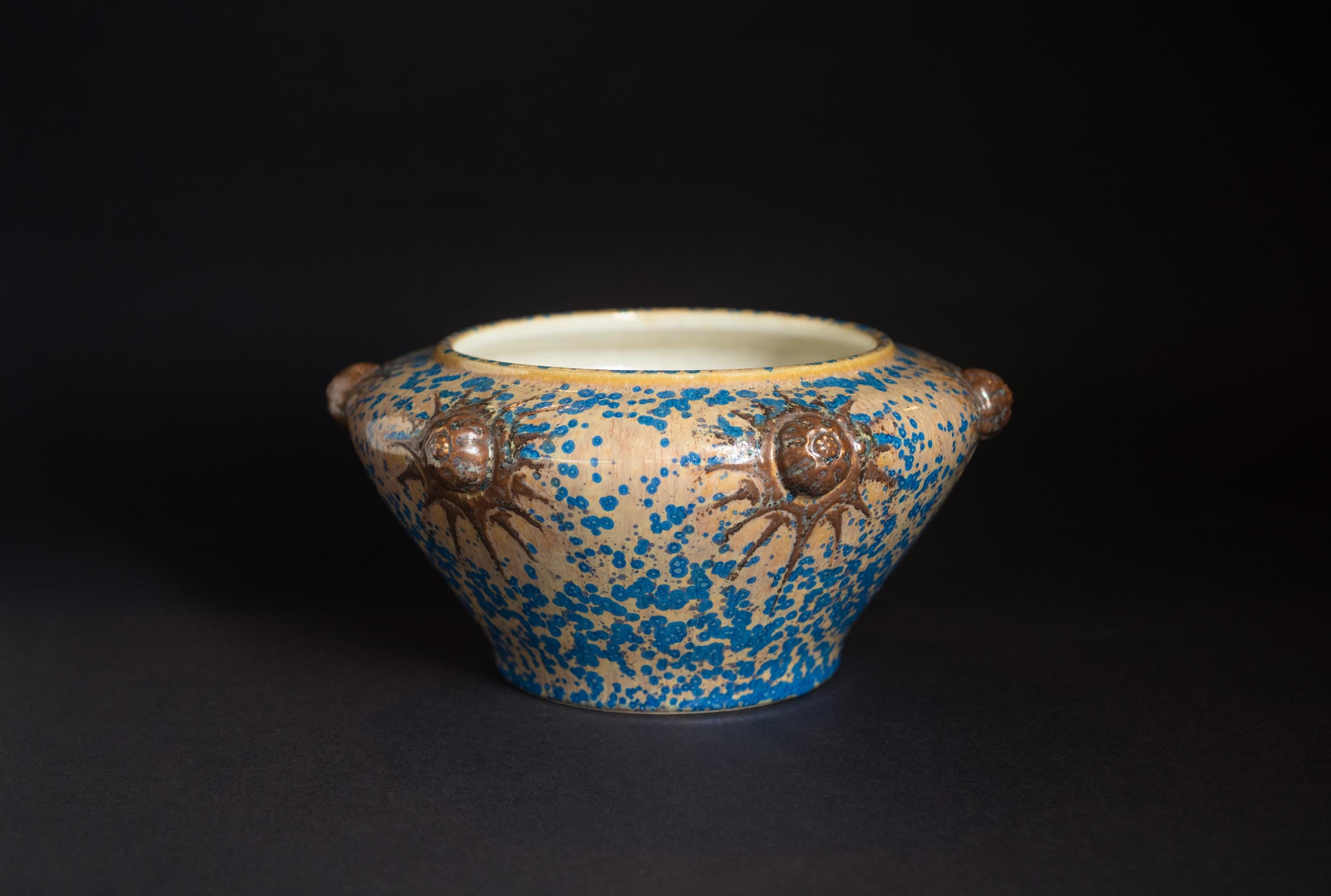 Striking bowl with crystalline iridized glaze.

Émile Diffloth (1856 – 1933) was a French ceramicist who was born in Couleuvre. He received his education at the École des Arts Décoratifs in Paris. In 1899, he became artistic director of Kéramis,