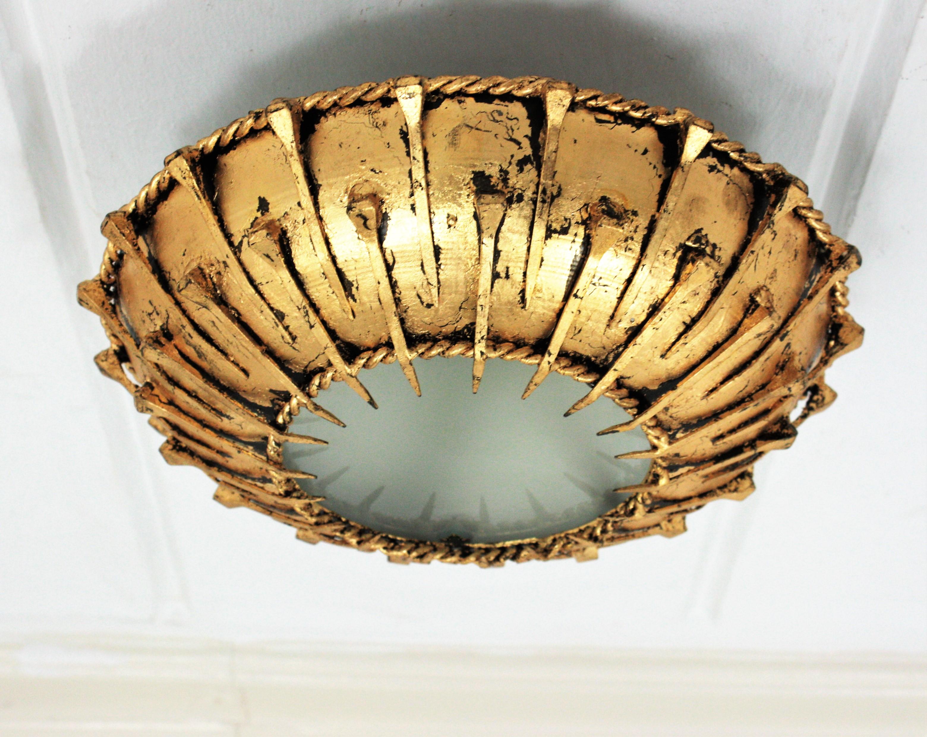 French Sunburst Brutalist Ceiling Light Fixture with Nail Motifs, Gilt Iron and Glass For Sale