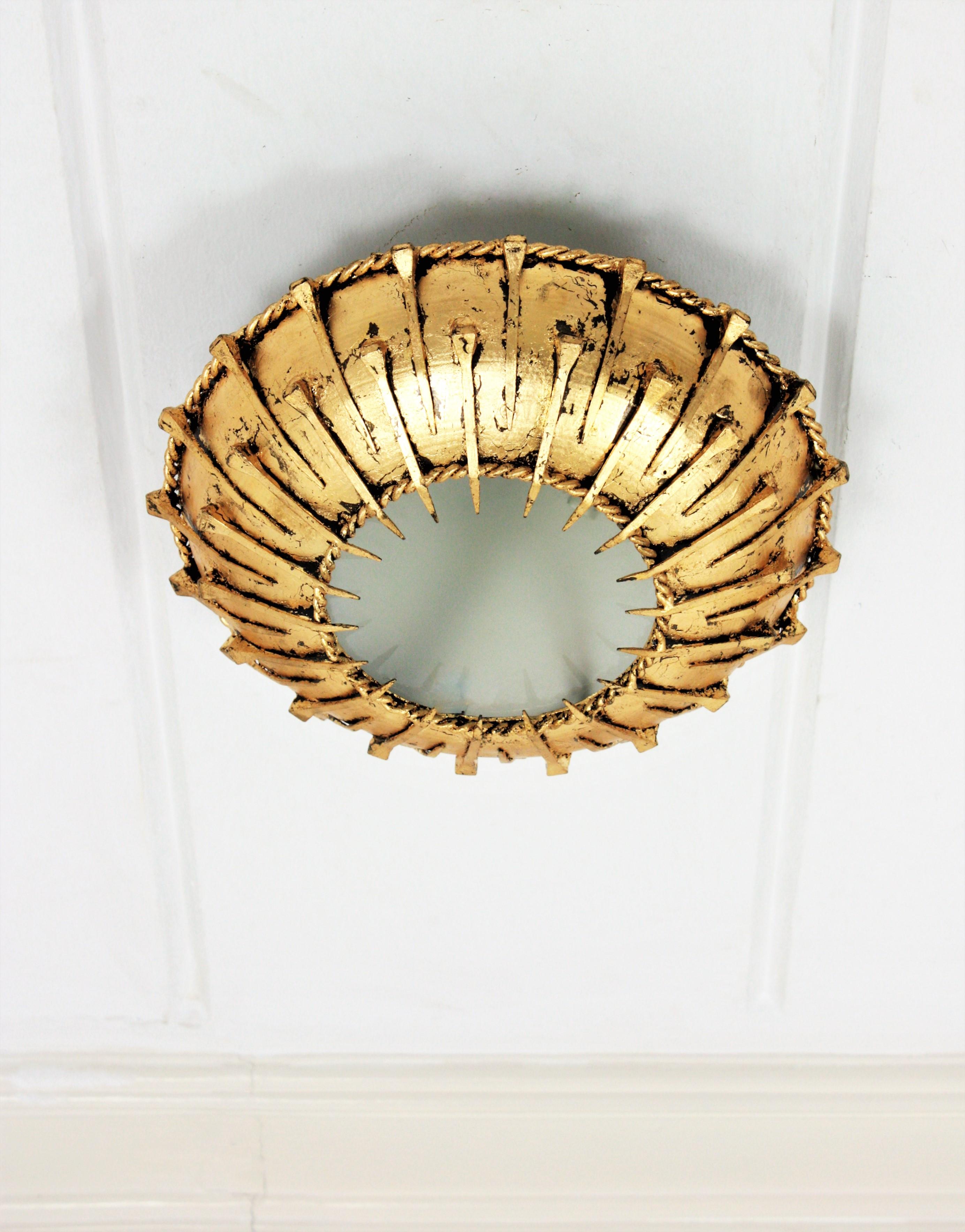 Hammered Sunburst Brutalist Ceiling Light Fixture with Nail Motifs, Gilt Iron and Glass For Sale