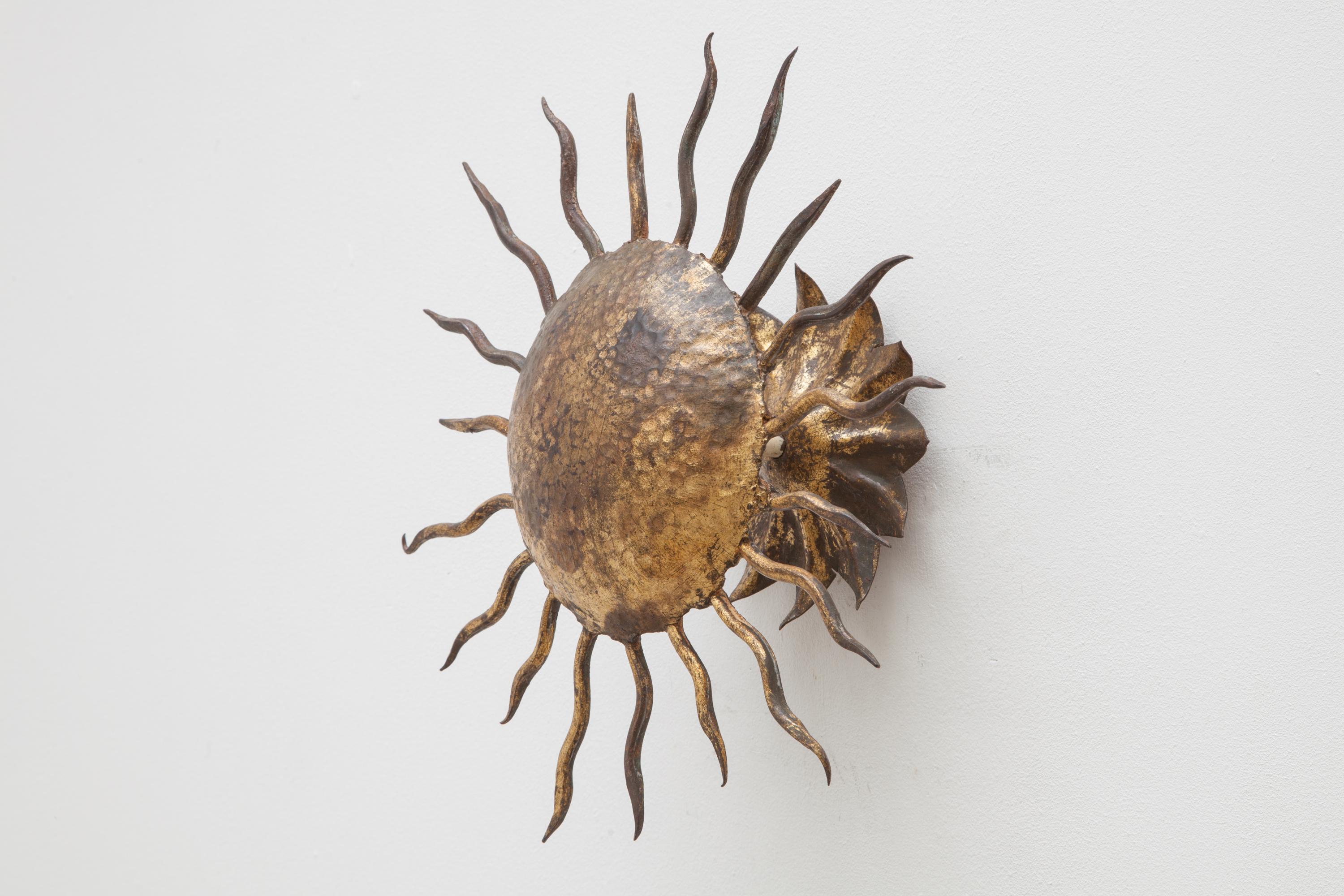 Surrealist sun a wrought iron and hammered metal face sunburst ceiling or wall light fixture, 1950s piece of craftsmanship
Lit by two bulbs will make a statement in most settings.
 